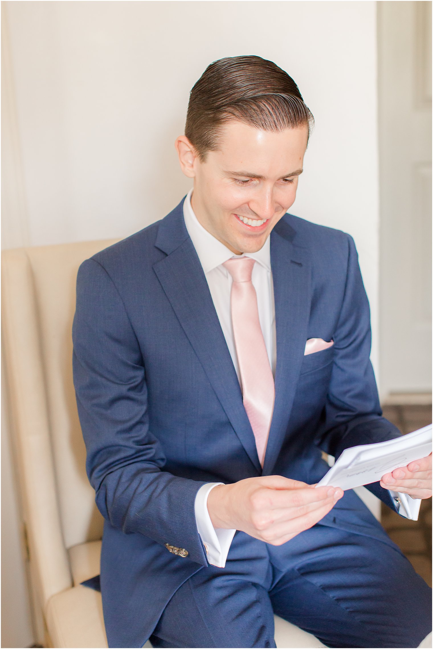 groom reads letter from bride on wedding day