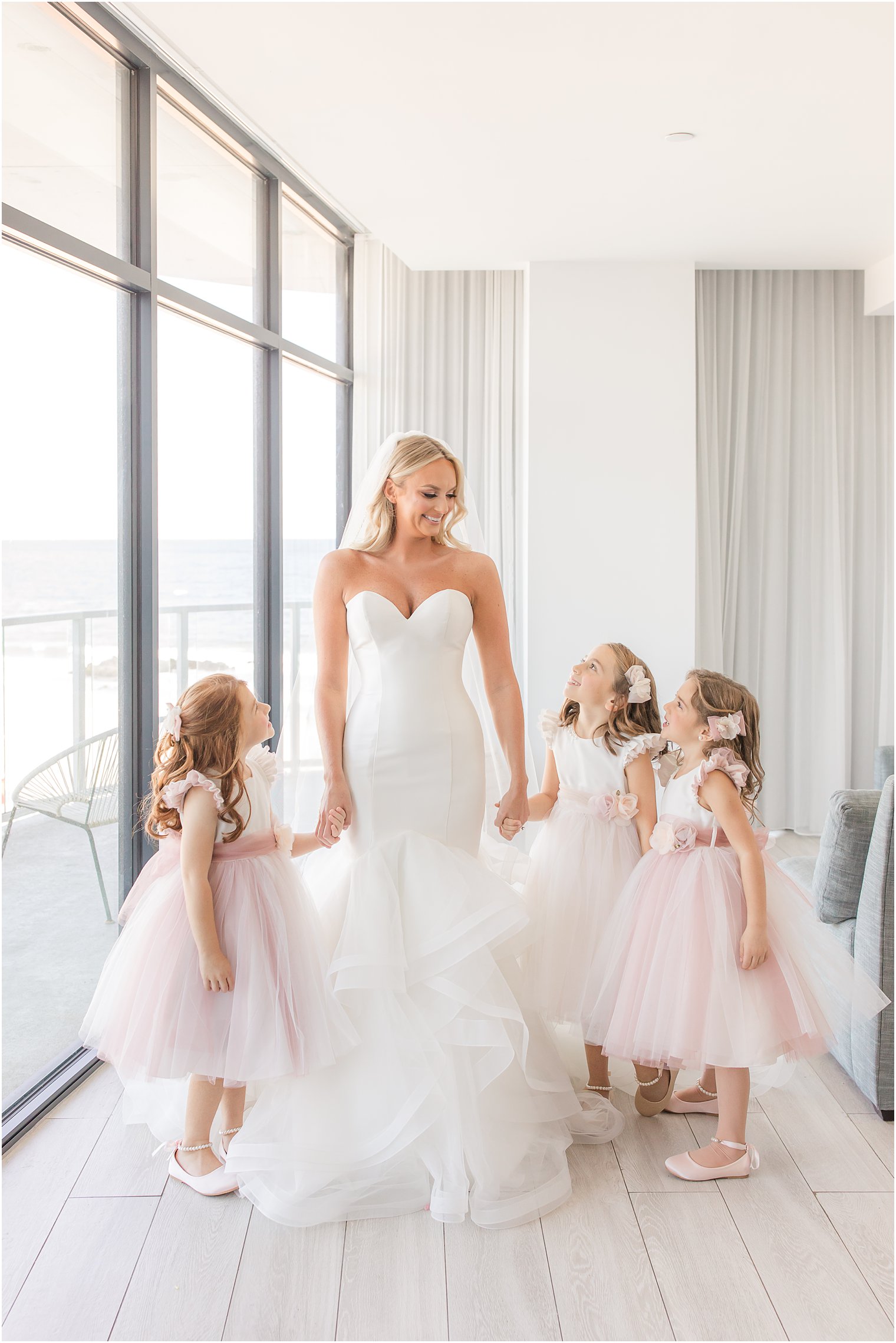 bride prepares with flower girls on wedding day