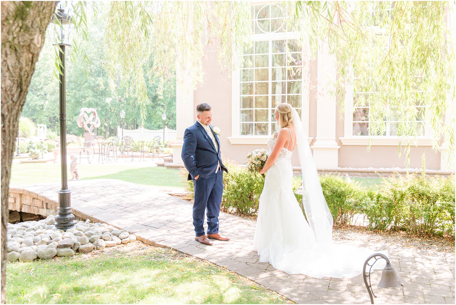 bride and groom look at each other during first look outside Brigalias