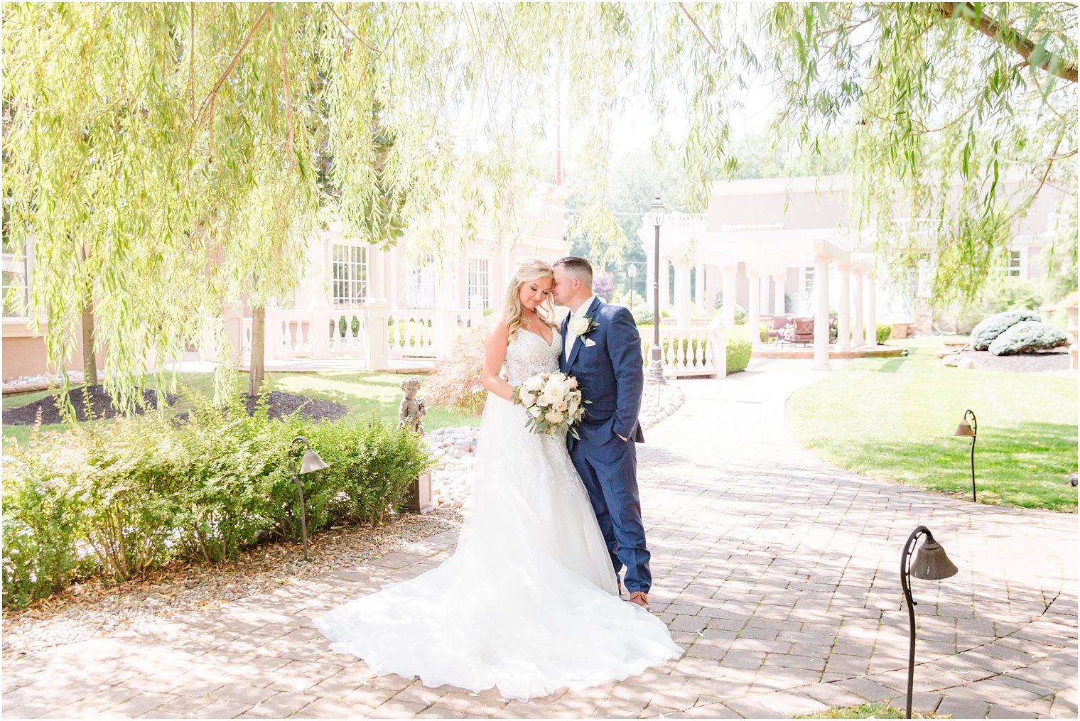 groom nuzzles bride's cheek during Brigalias wedding portriats under weeping willow 