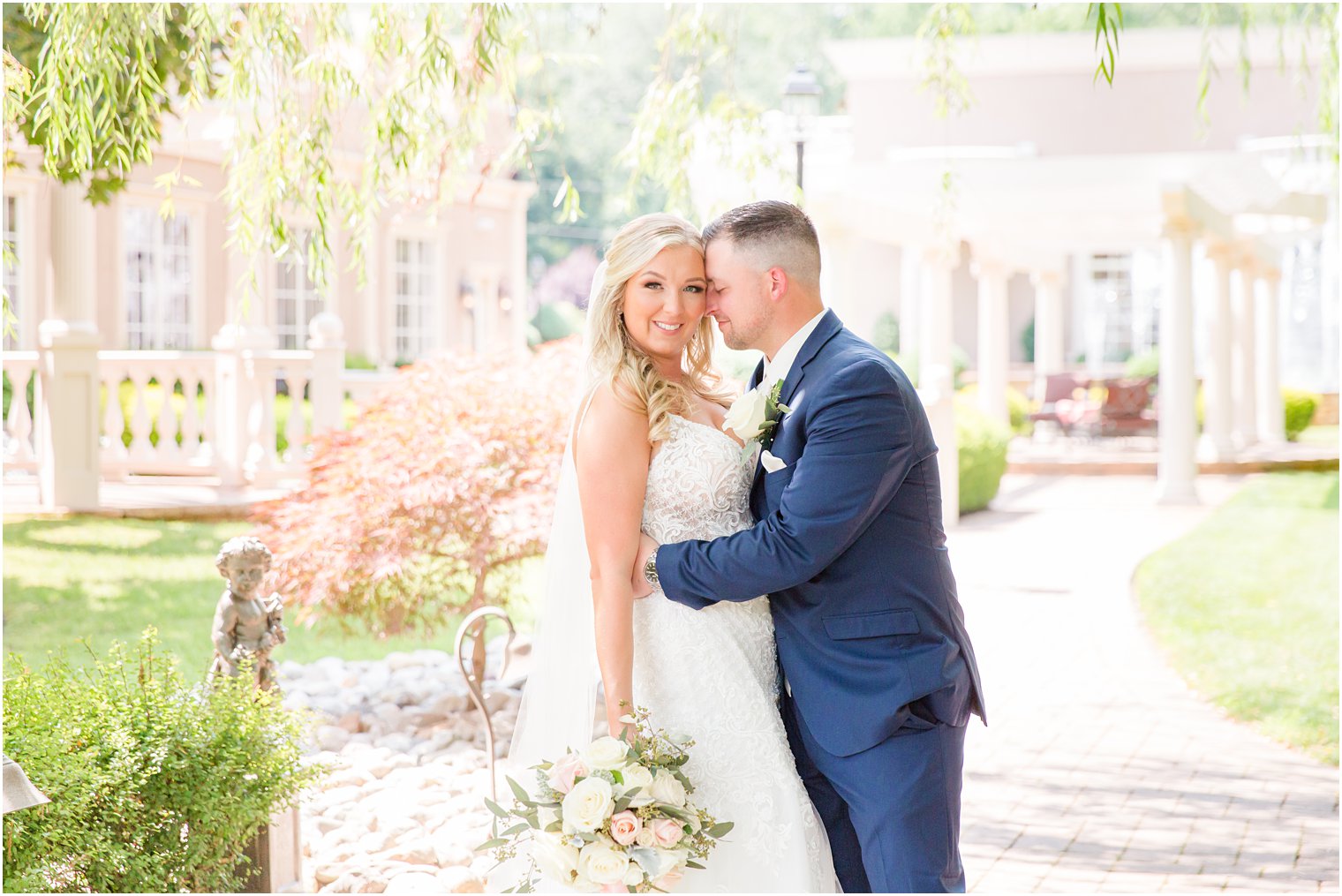 groom nuzzles bride's cheek during NJ wedding portriats by pergola 