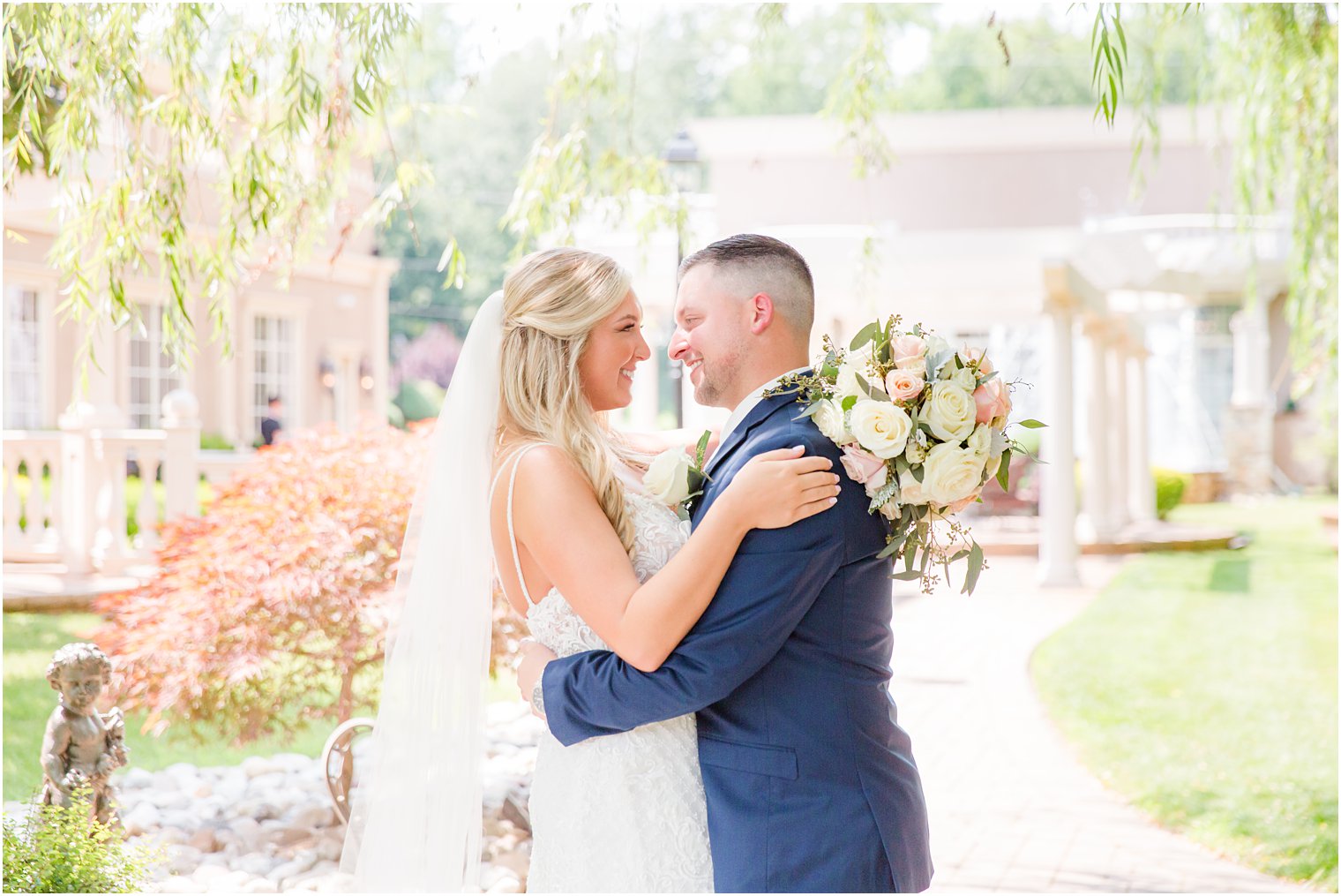 bride and groom hug laughing during NJ wedding portraits 