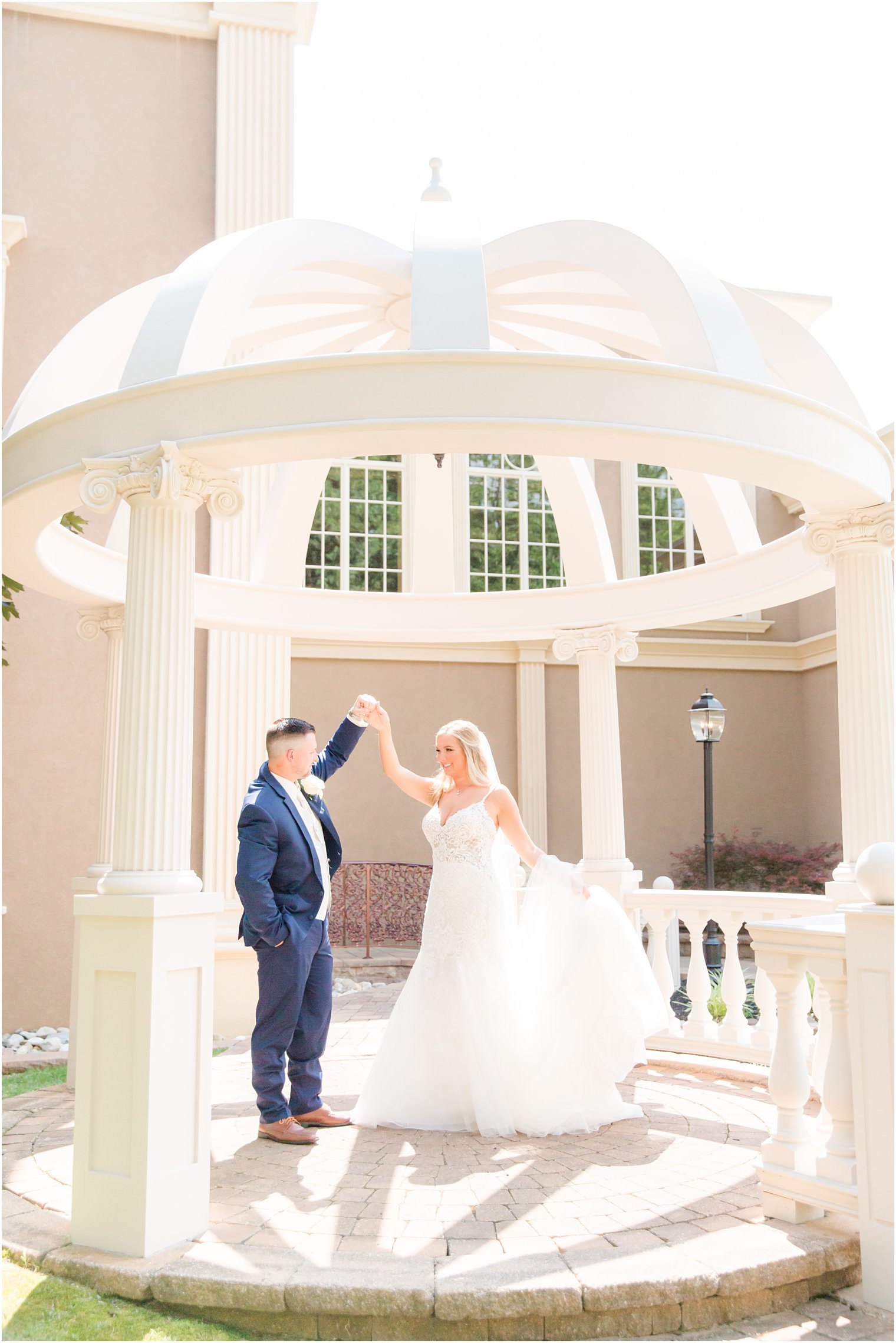 groom twirls bride in gazebo at Brigalias in Stokersville NJ 