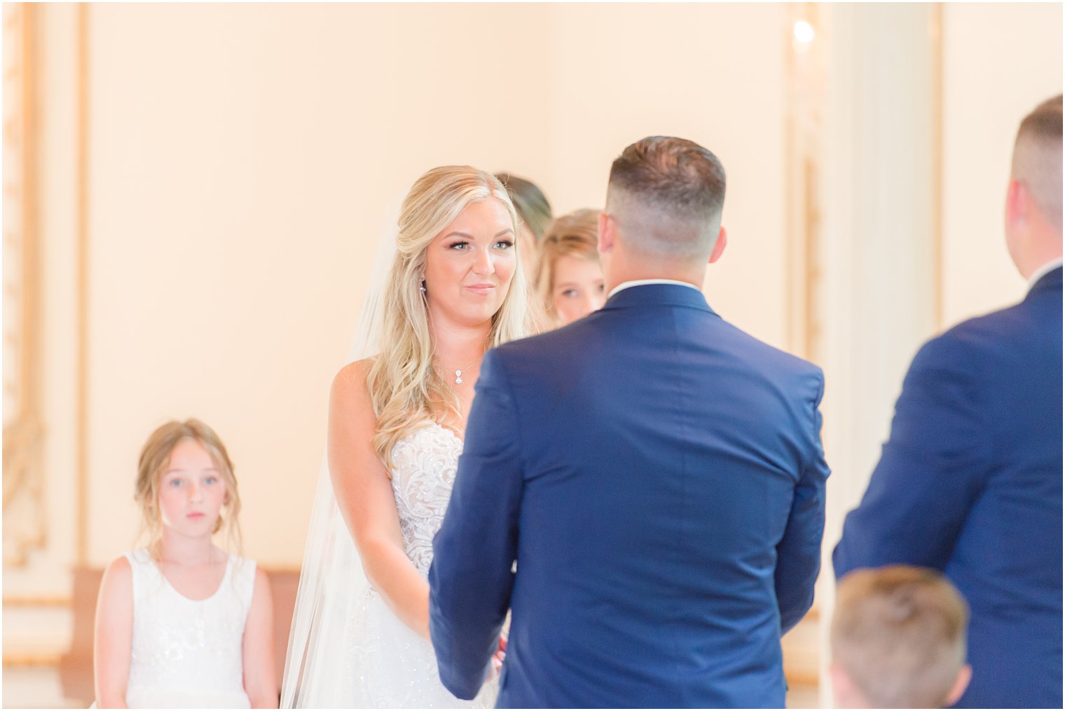 bride looks at groom while exchanging vows during NJ wedding ceremony 