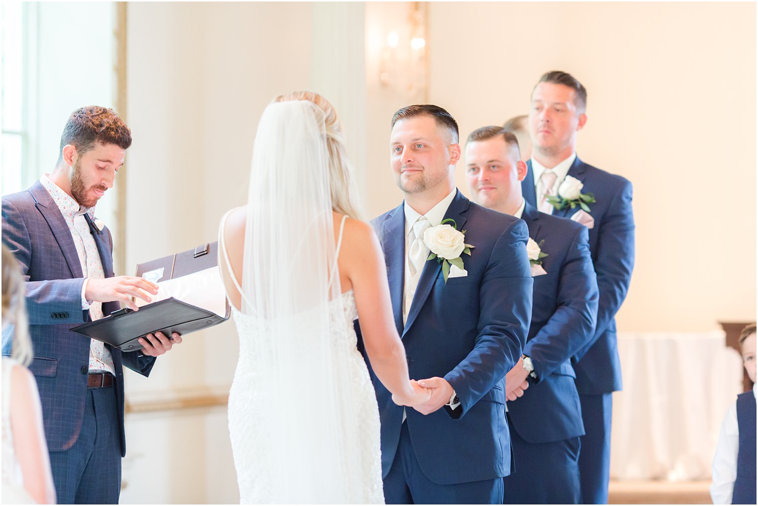 groom smiles at bride during Brigalias wedding ceremony in New Jersey 