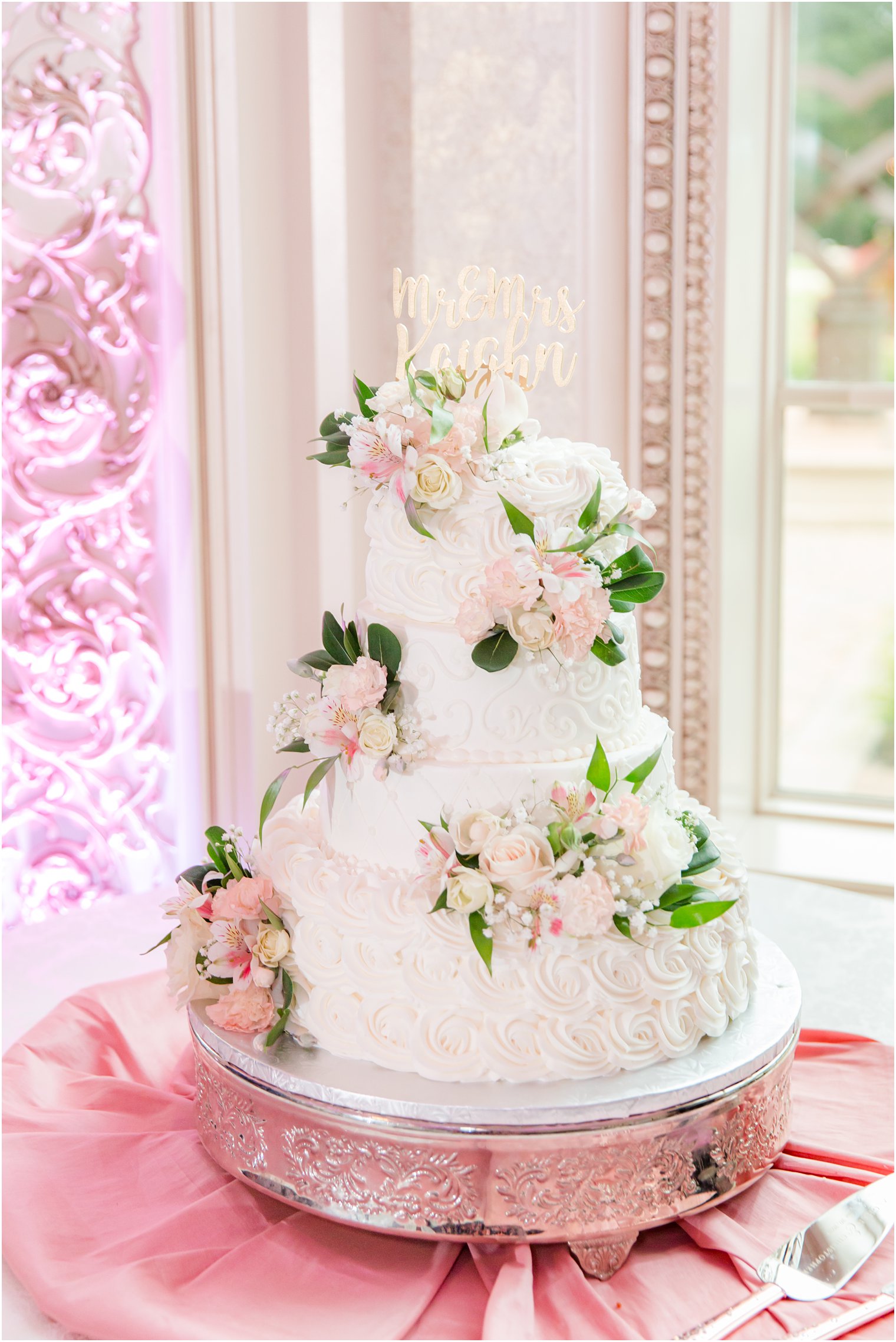 tiered wedding cake with pale pink flower accents for NJ wedding reception 