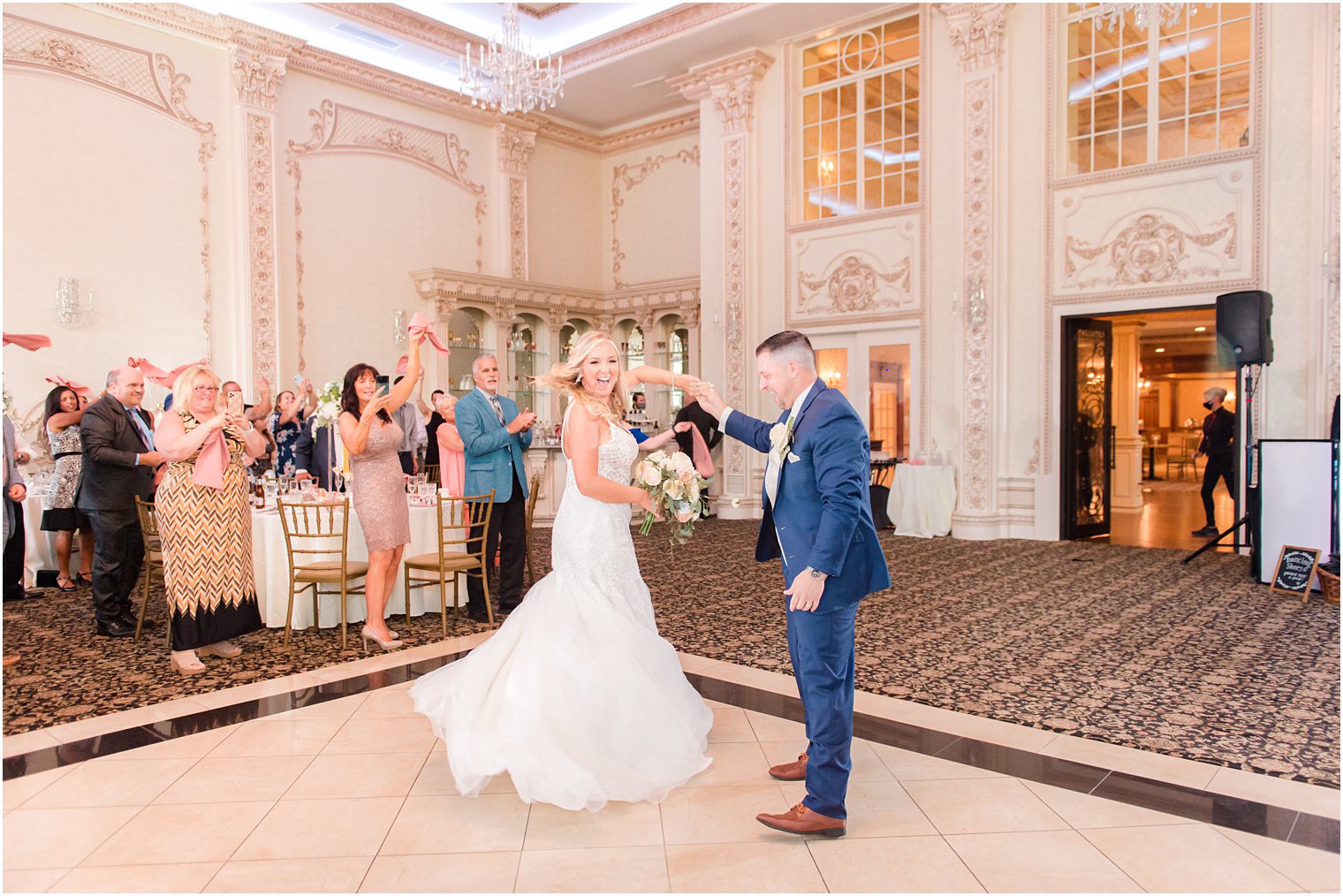 groom twirls bride during NJ wedding reception at Brigalias