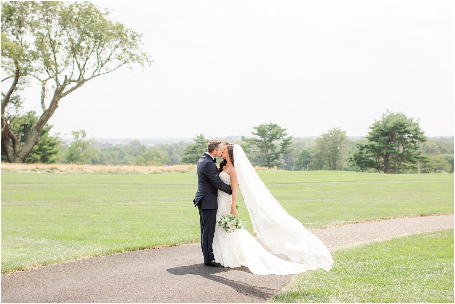 newlyweds kiss on golf course in New Jersey