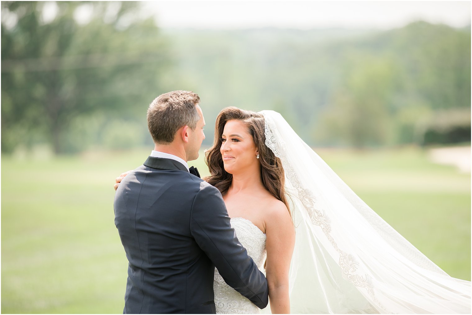 bride and groom smile during wedding photos at Navesink Country Club
