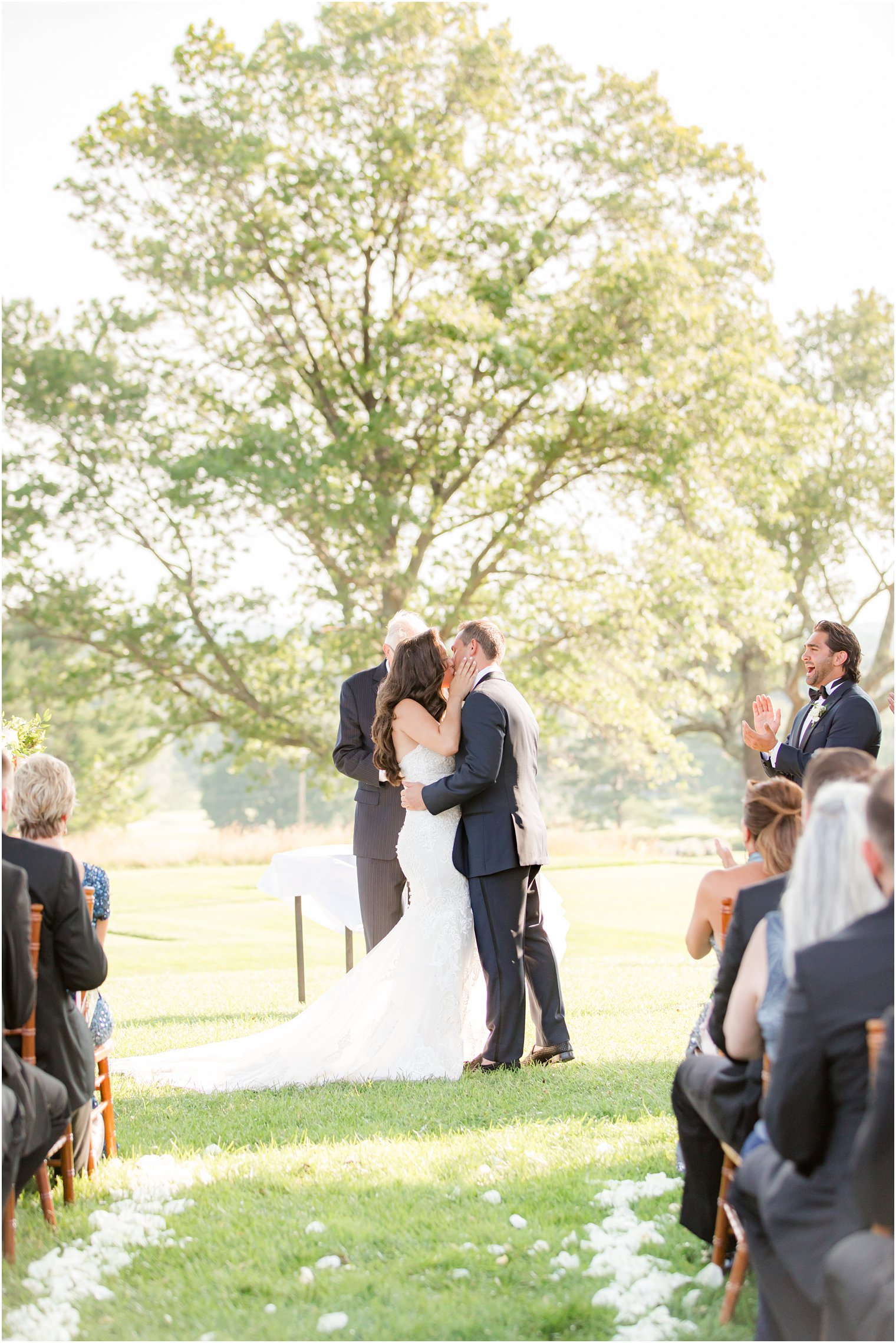 newlyweds kiss during Navesink Country Club wedding ceremony