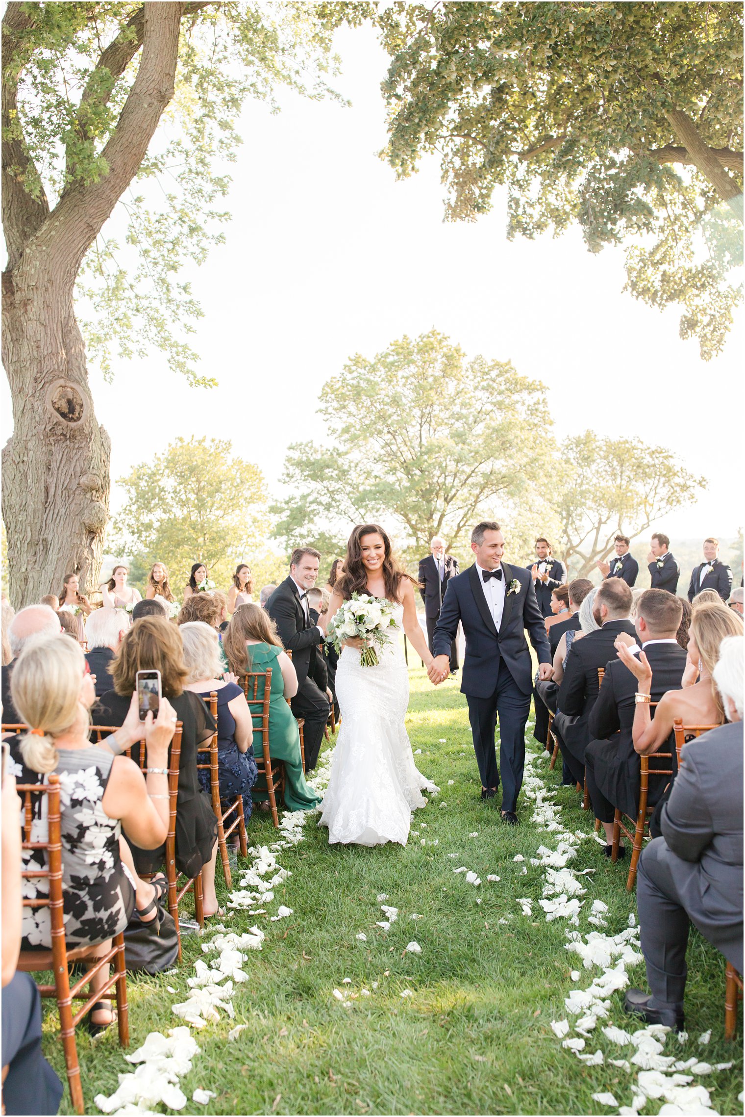 newlyweds walk up aisle after ceremony in New Jersey 