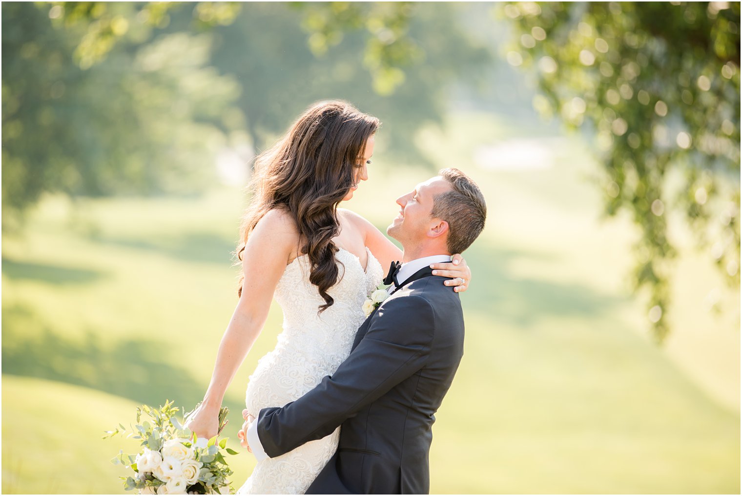 groom lifs bride during wedding photos in New Jersey