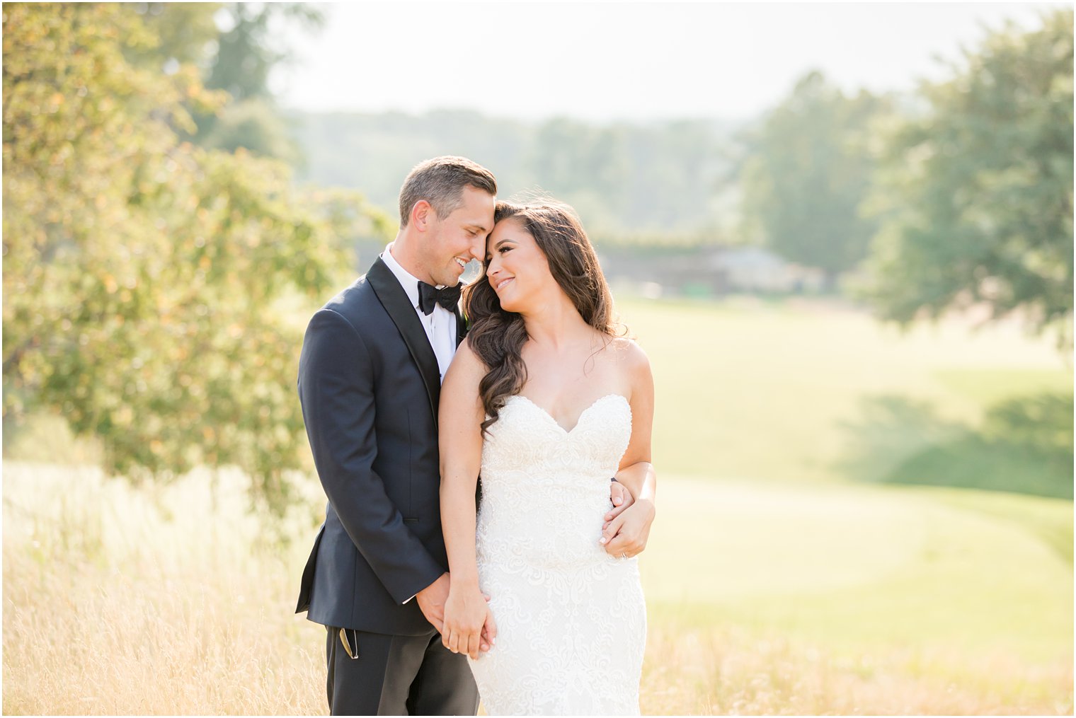 bride and groom touch foreheads hugging during NJ wedding photos