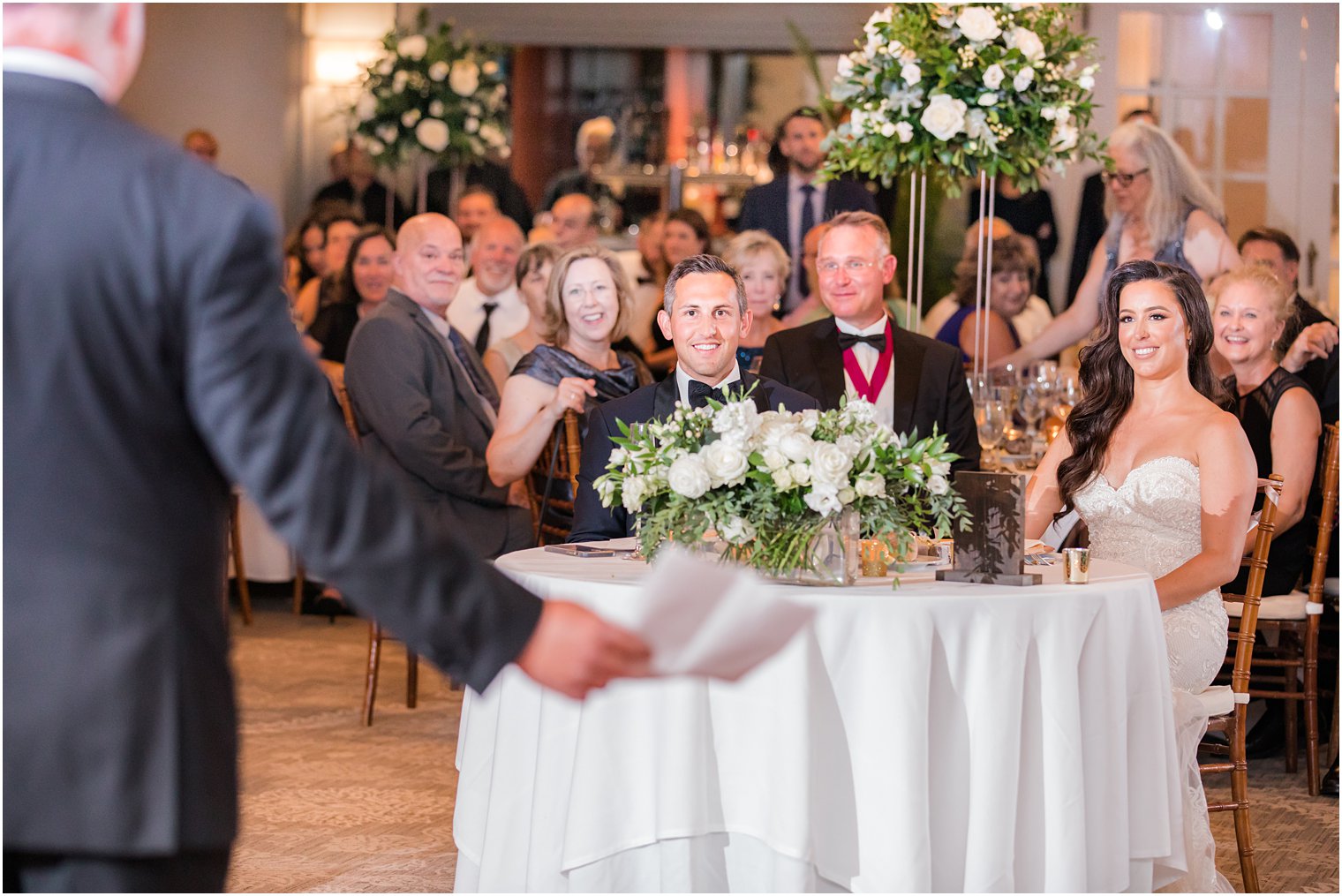 bride and groom listen to toast during Navesink Country Club reception