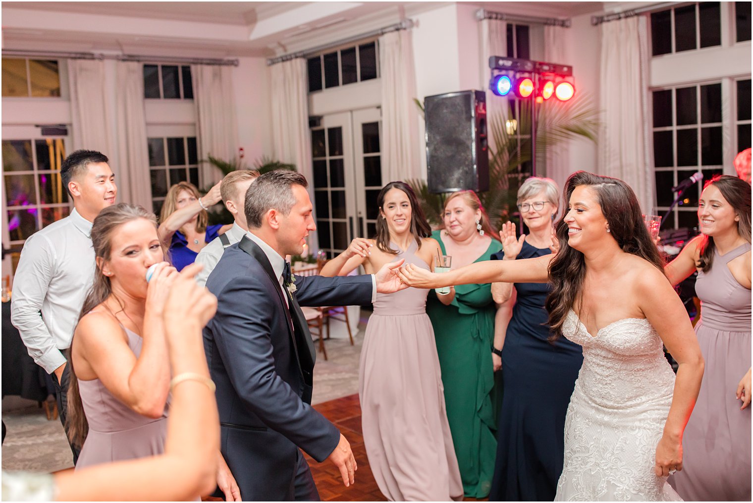 bride and groom dance with wedding guests at Navesink Country Club