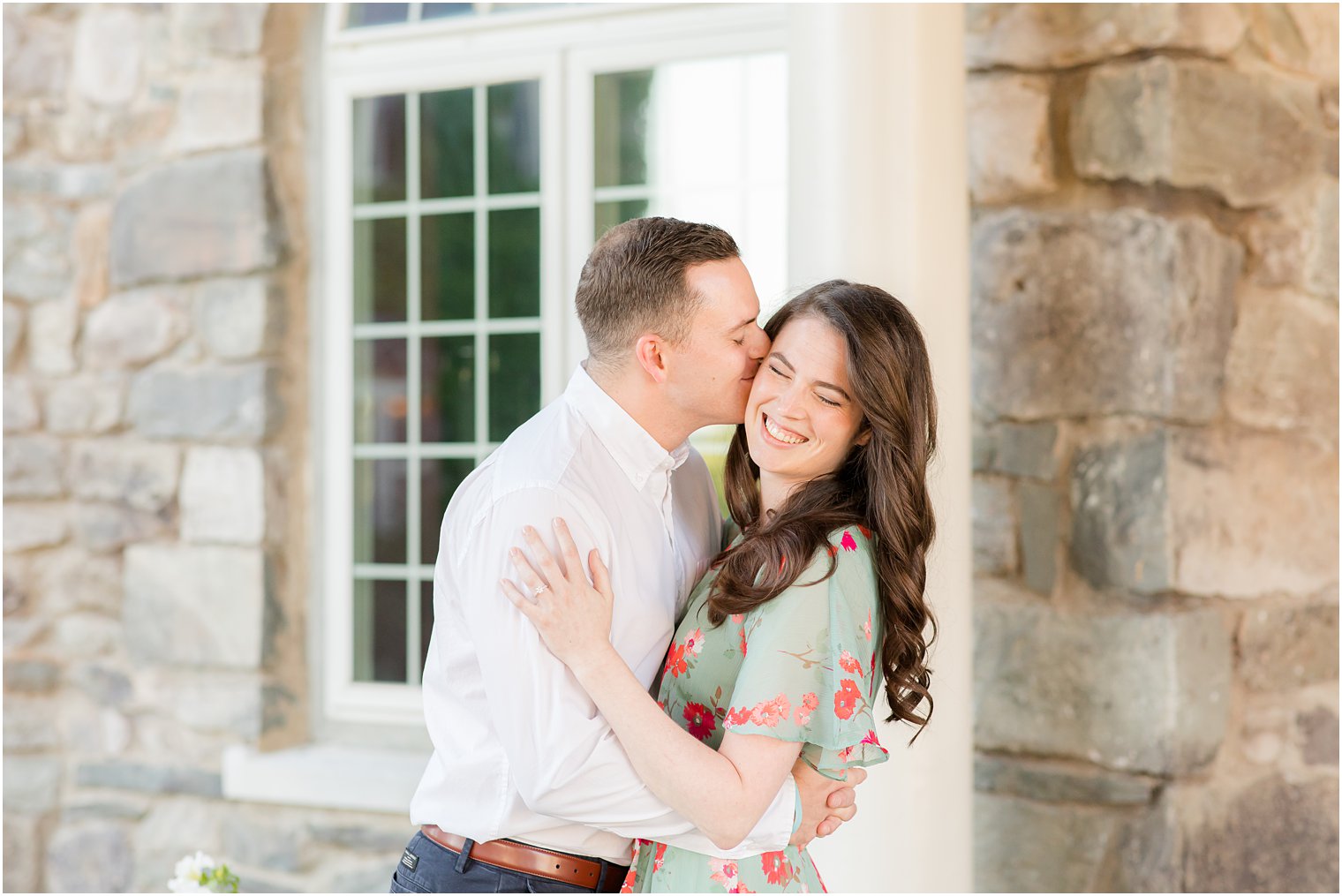 groom kisses bride's cheek duding ponchos PA engagement photos