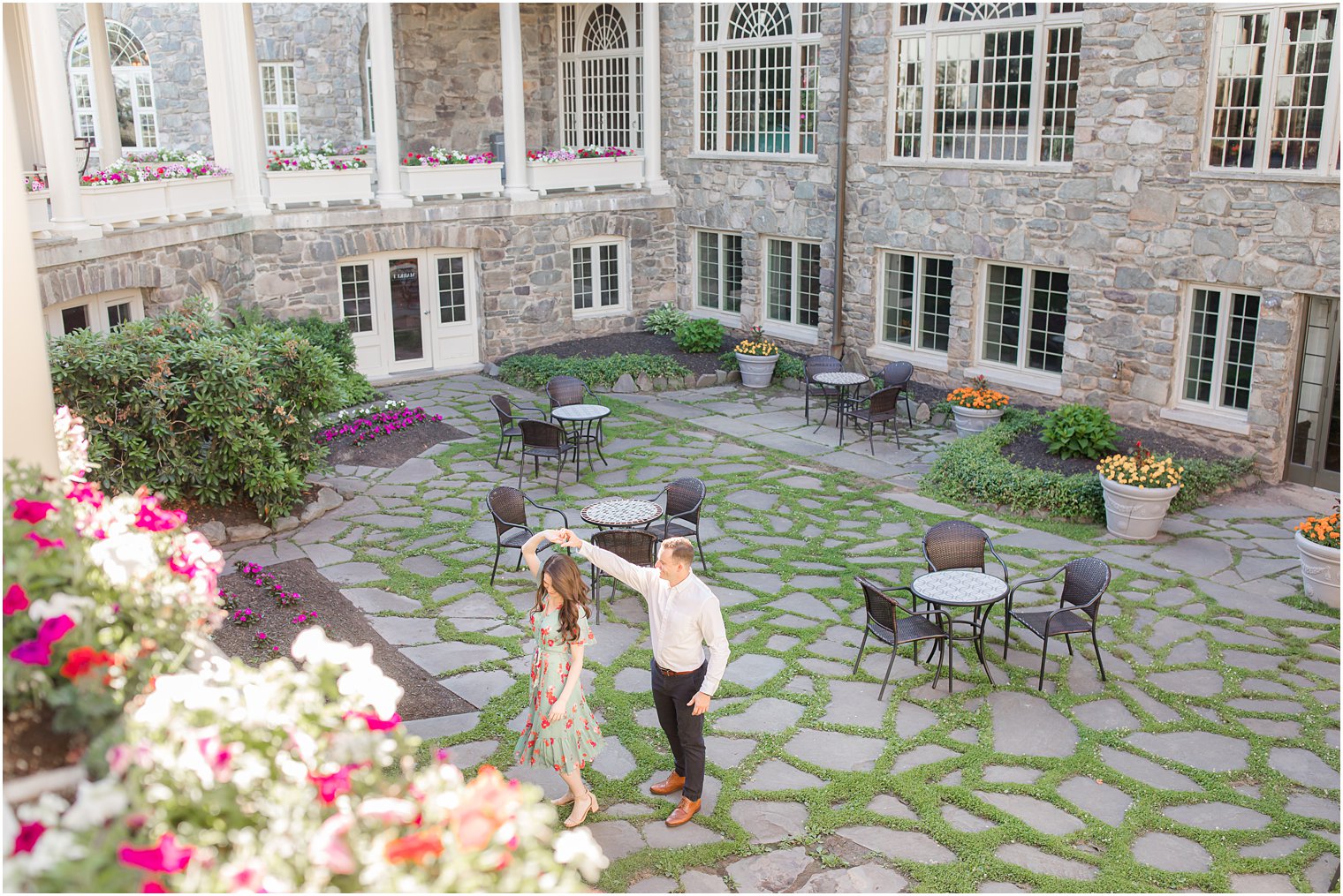 groom twirls bride in courtyard at Skytop Lodge