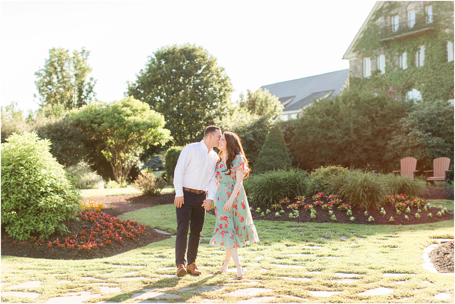 groom leans and kisses bride's cheek during PA engagement portraits 
