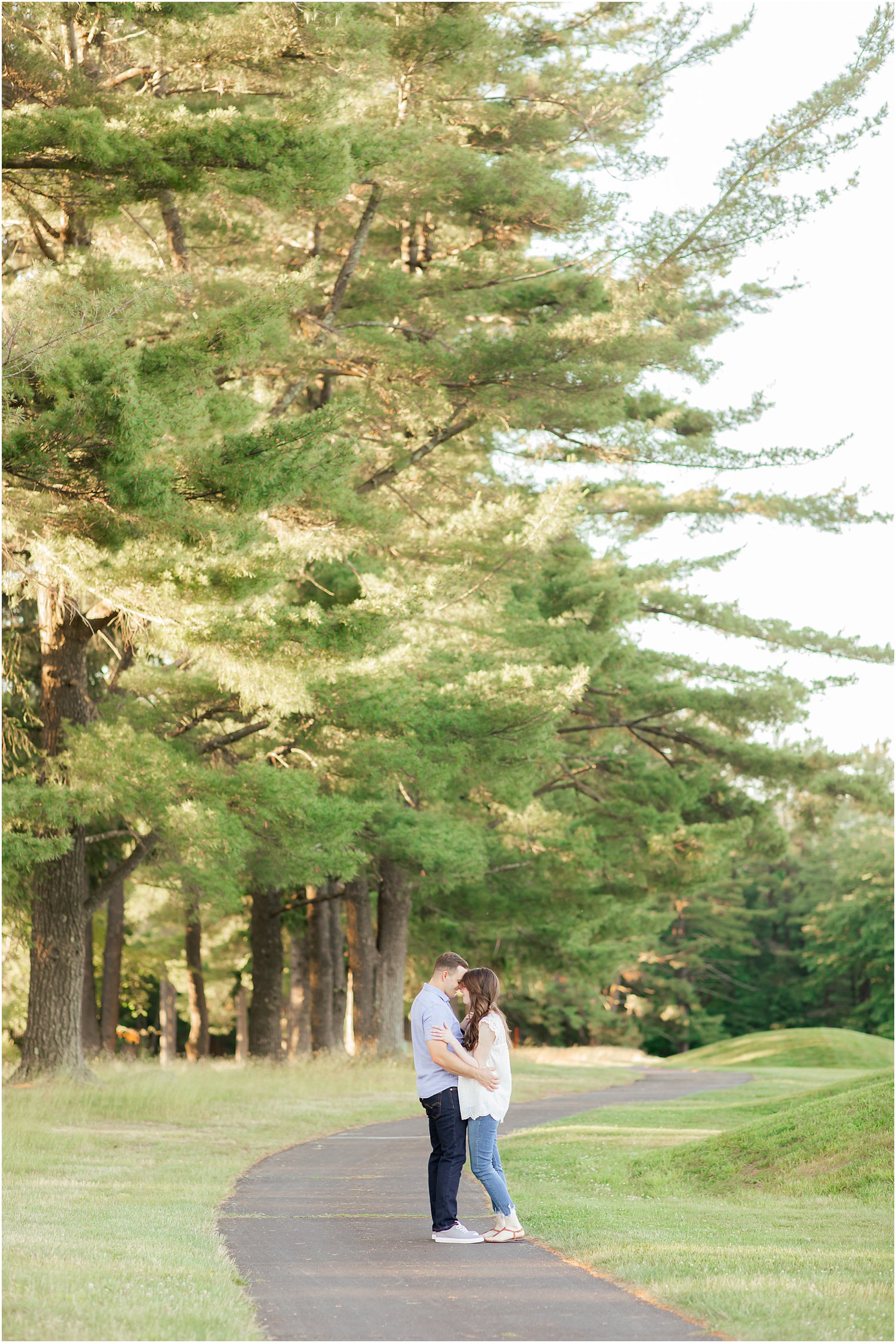 engaged couple poses on sidewalk in the Poconos PA