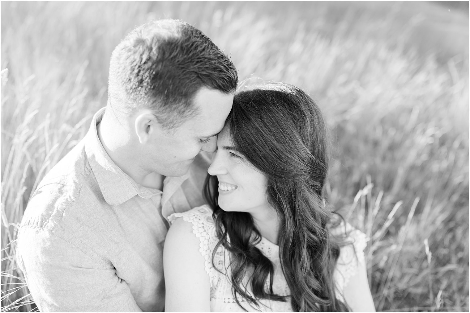 bride and groom touch foreheads in grass in the Poconos PA