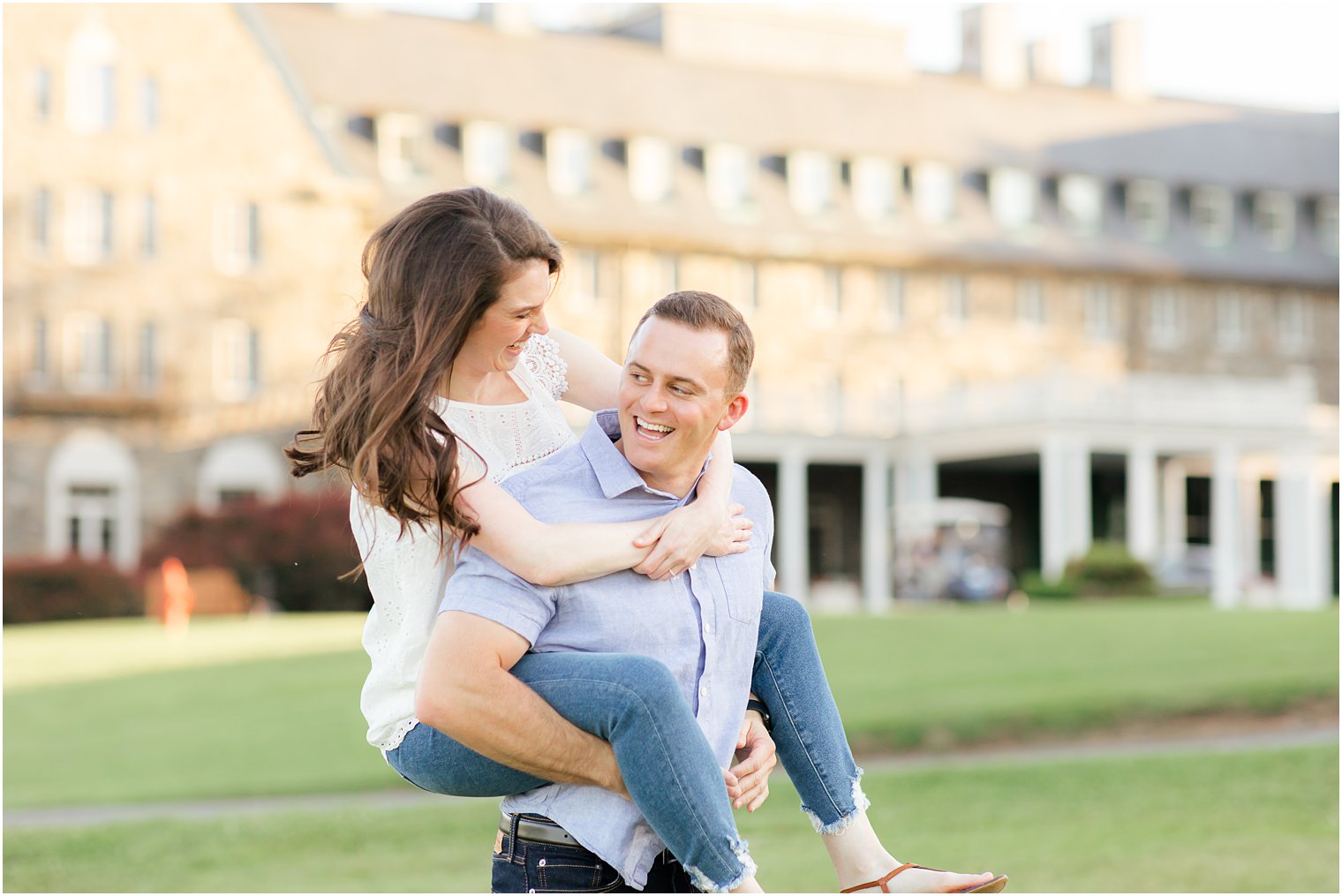 bride and groom lawn on lawn during engagement photos in the Poconos PA