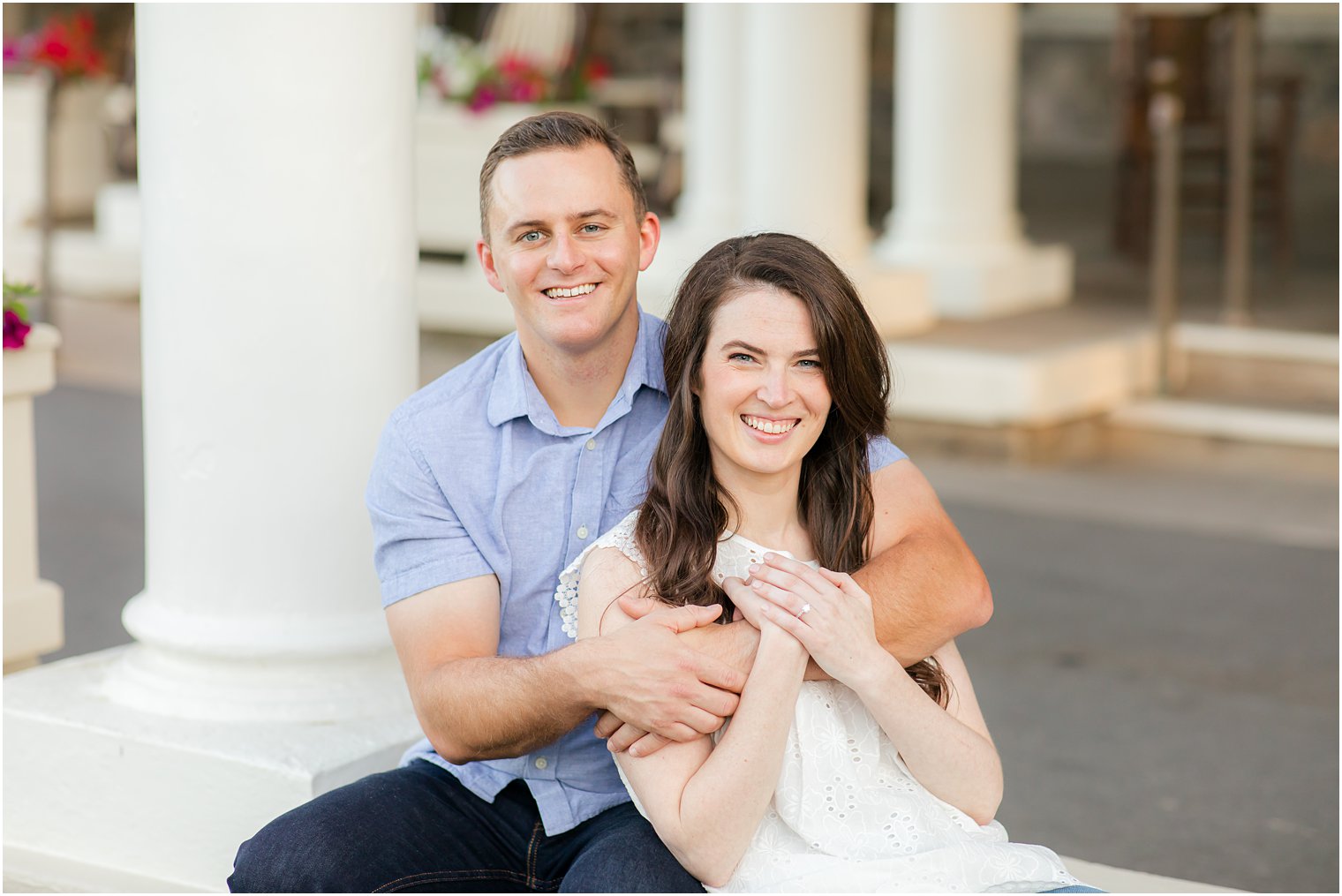 bride and groom sit on steps during Skytop Lodge engagement photos