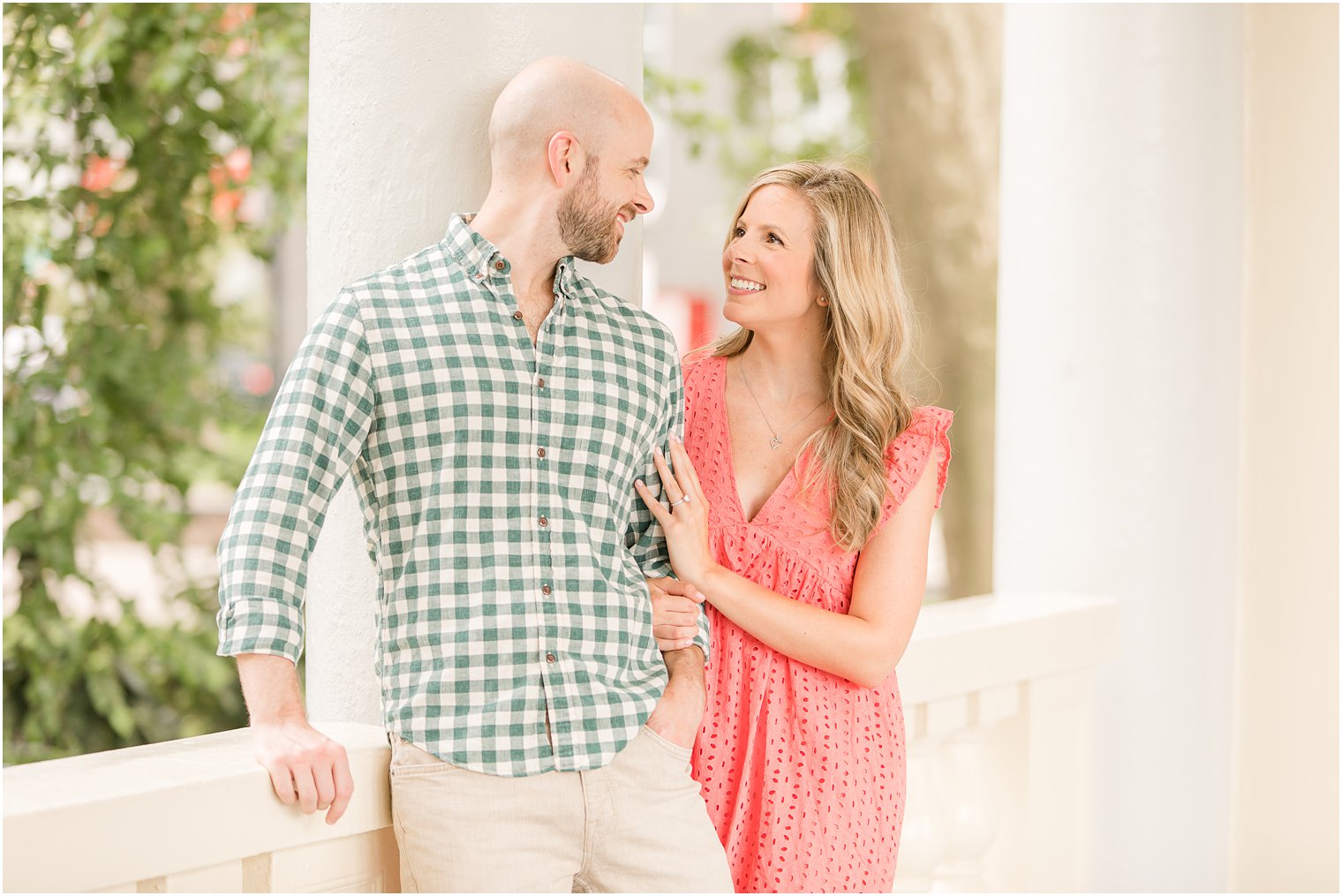 bride and groom pose by walkway with arches