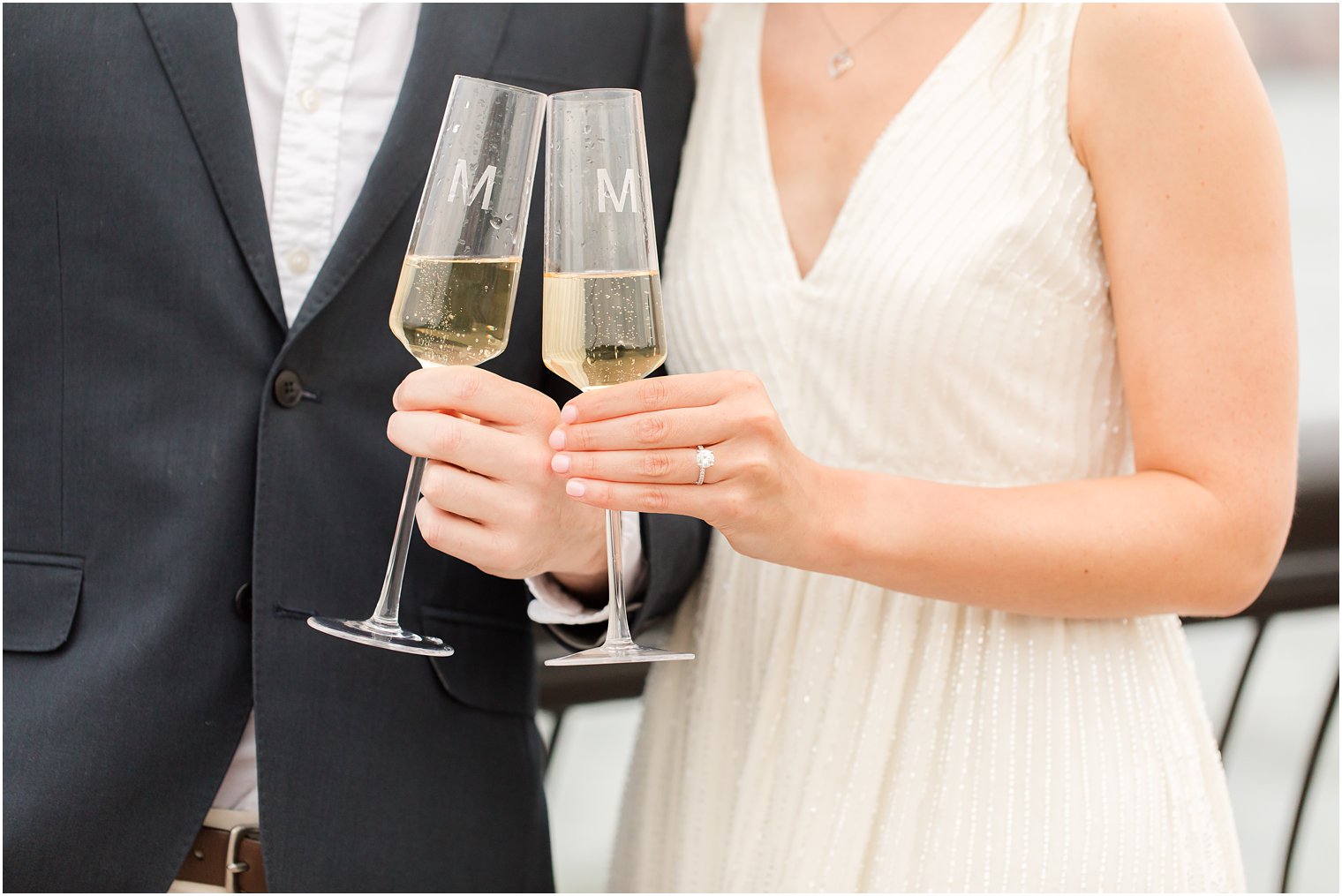 couple toasts with champagne during NJ engagement photos