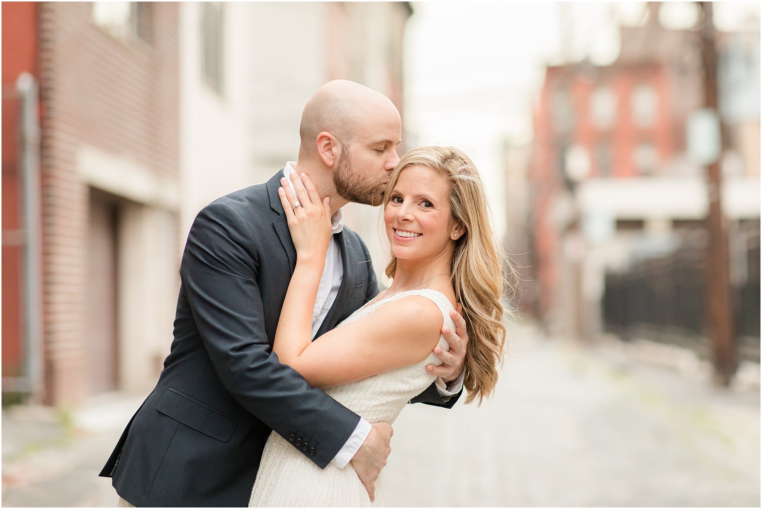 groom kisses bride's forehead during NJ engagement session