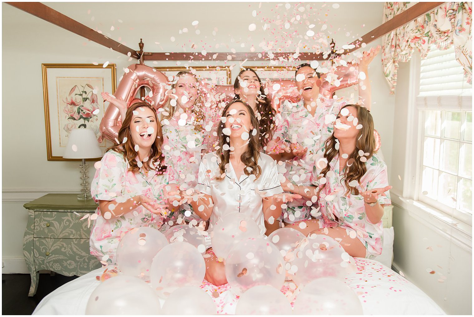 bride and bridesmaids toss confetti during wedding prep photos