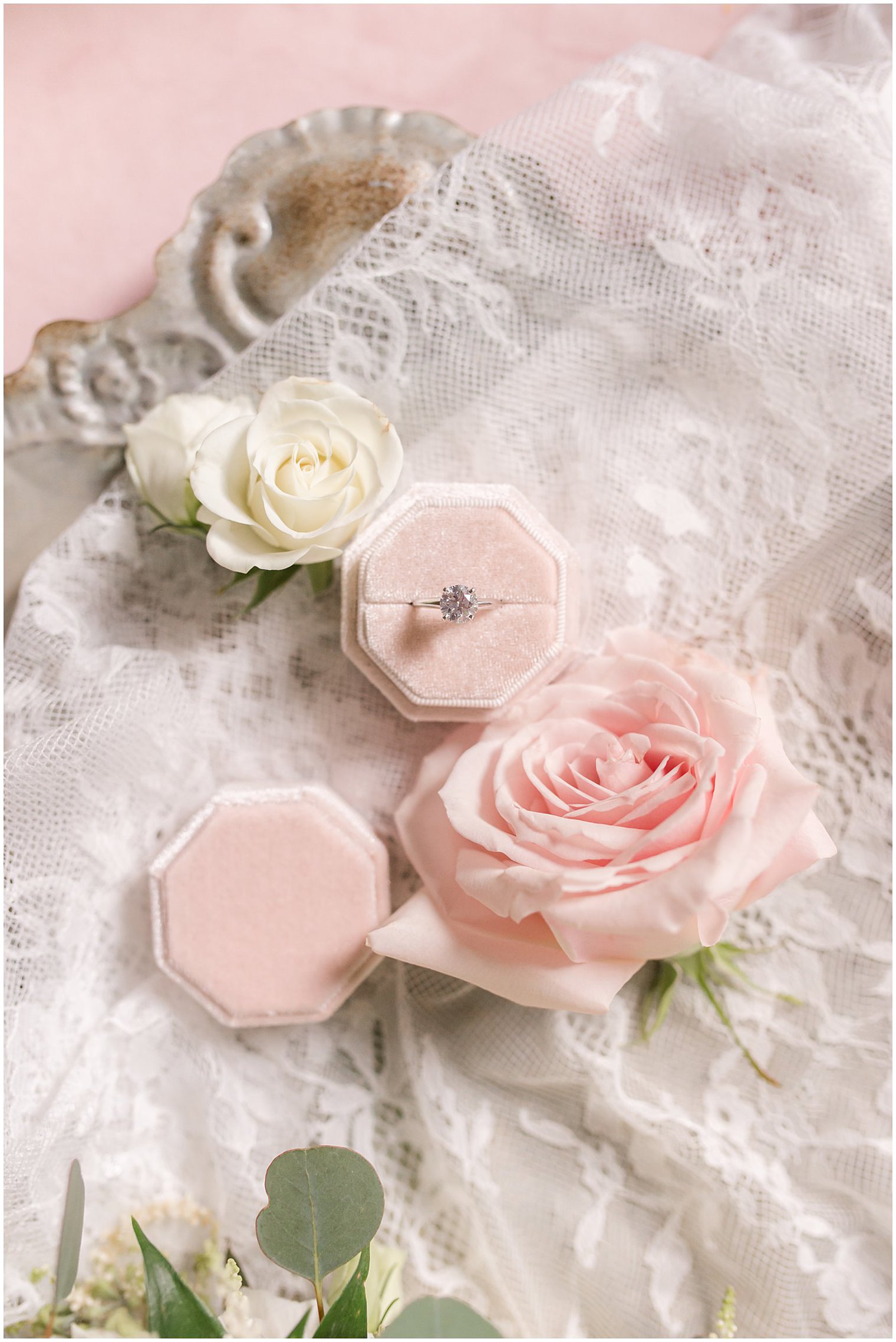 bride's engagement ring rests in pink ring box with florals