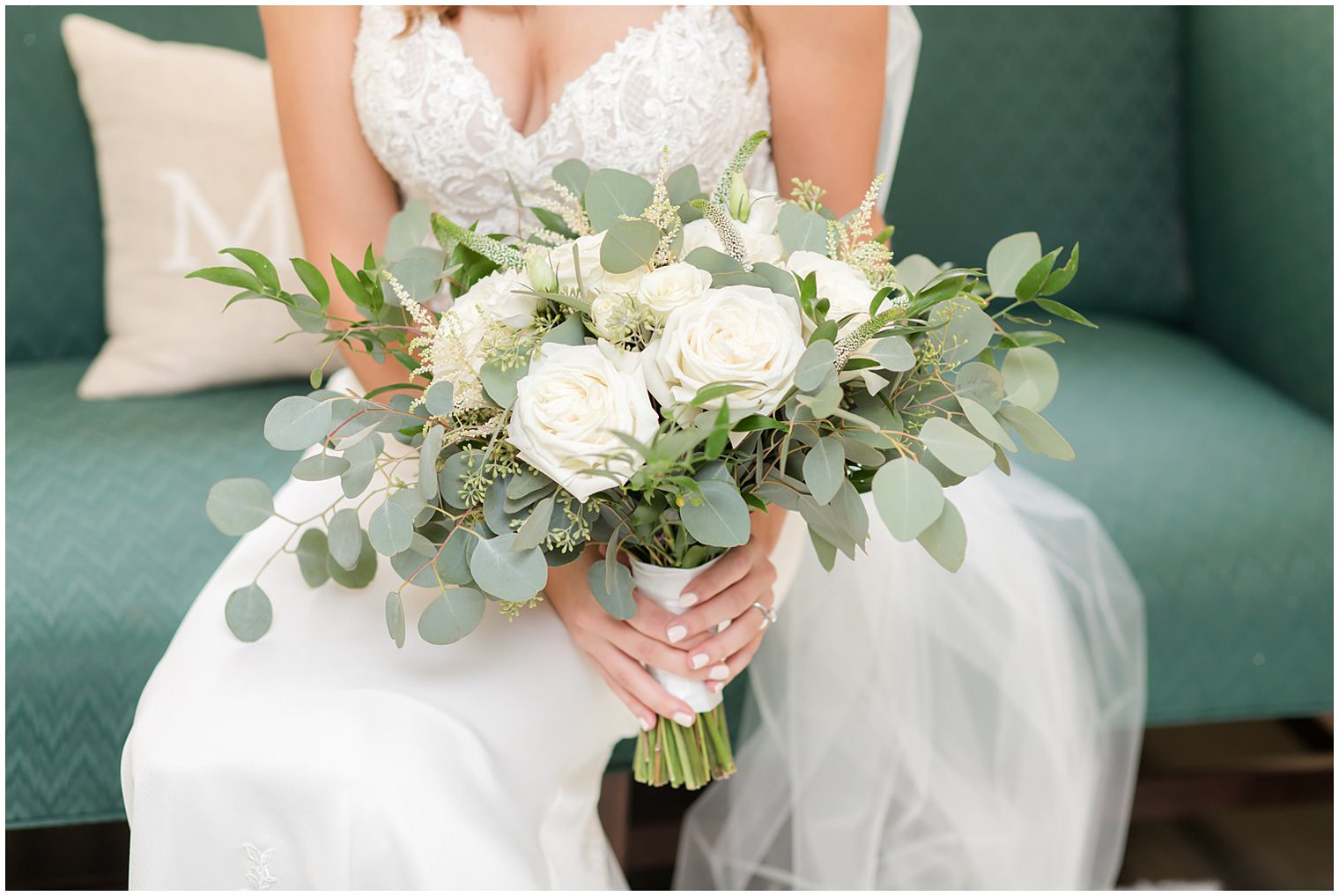 bride holds bouquet of all white flowers at the Inn at Fernbrook Farms