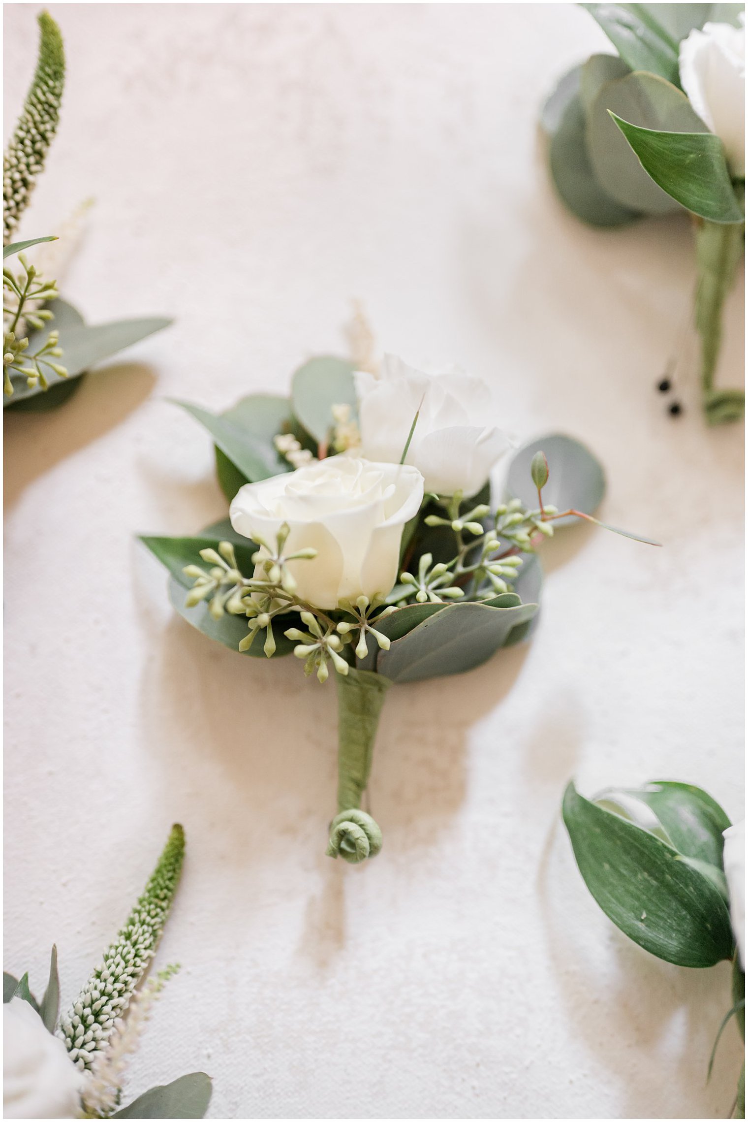 white rose boutonnière for the groom