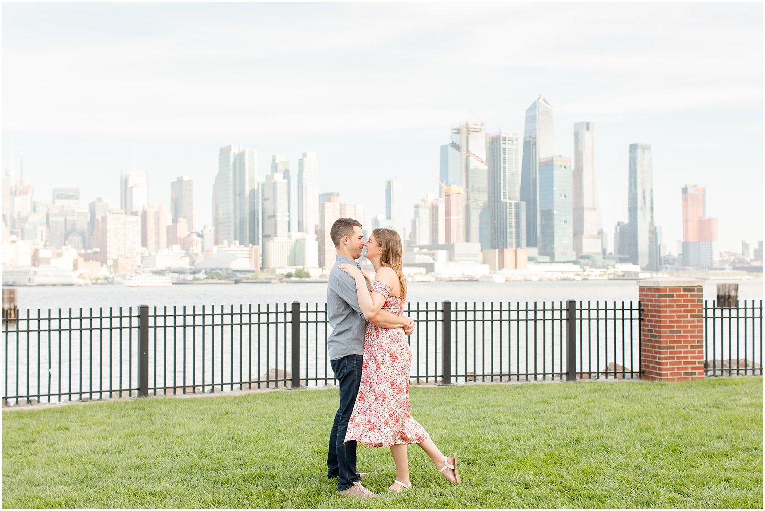 bride and groom hug in park during Weehawken NJ engagement photos 