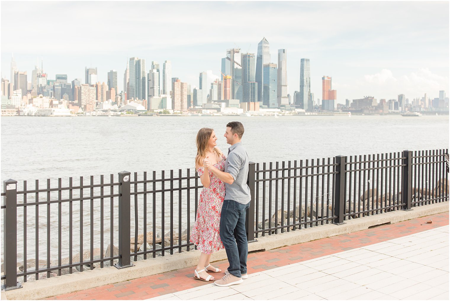 engaged couple dances during Weehawken waterfront engagement session 