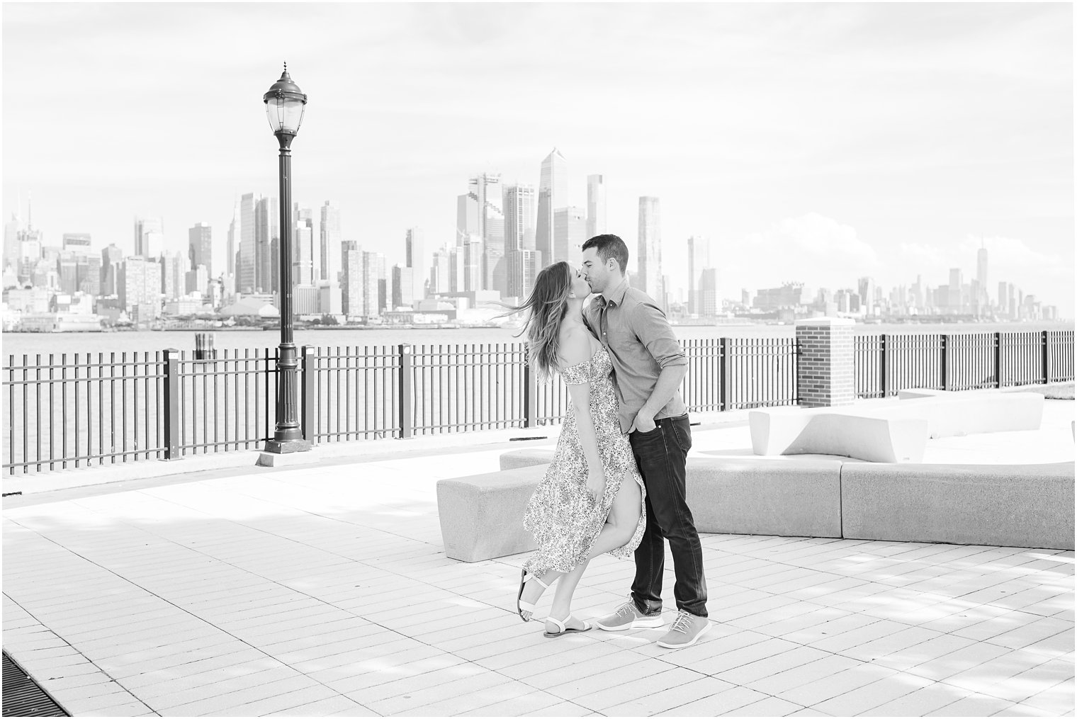 bride and groom kiss along waterfront in Weehawken New Jersey 