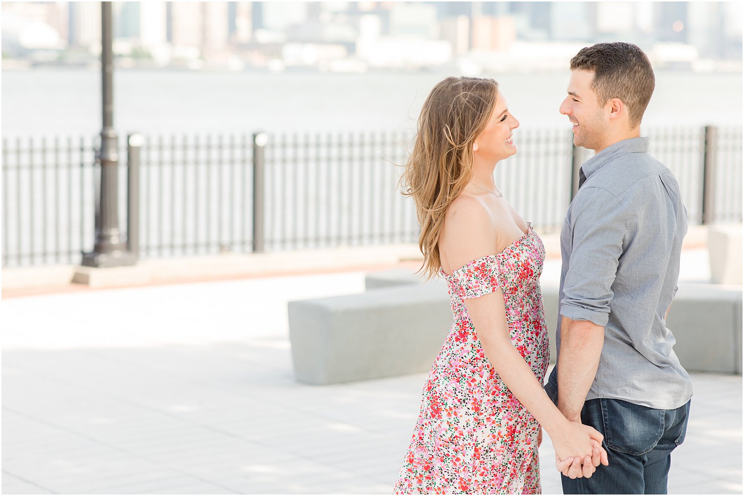 bride and groom hold hands smiling during NJ engagement session