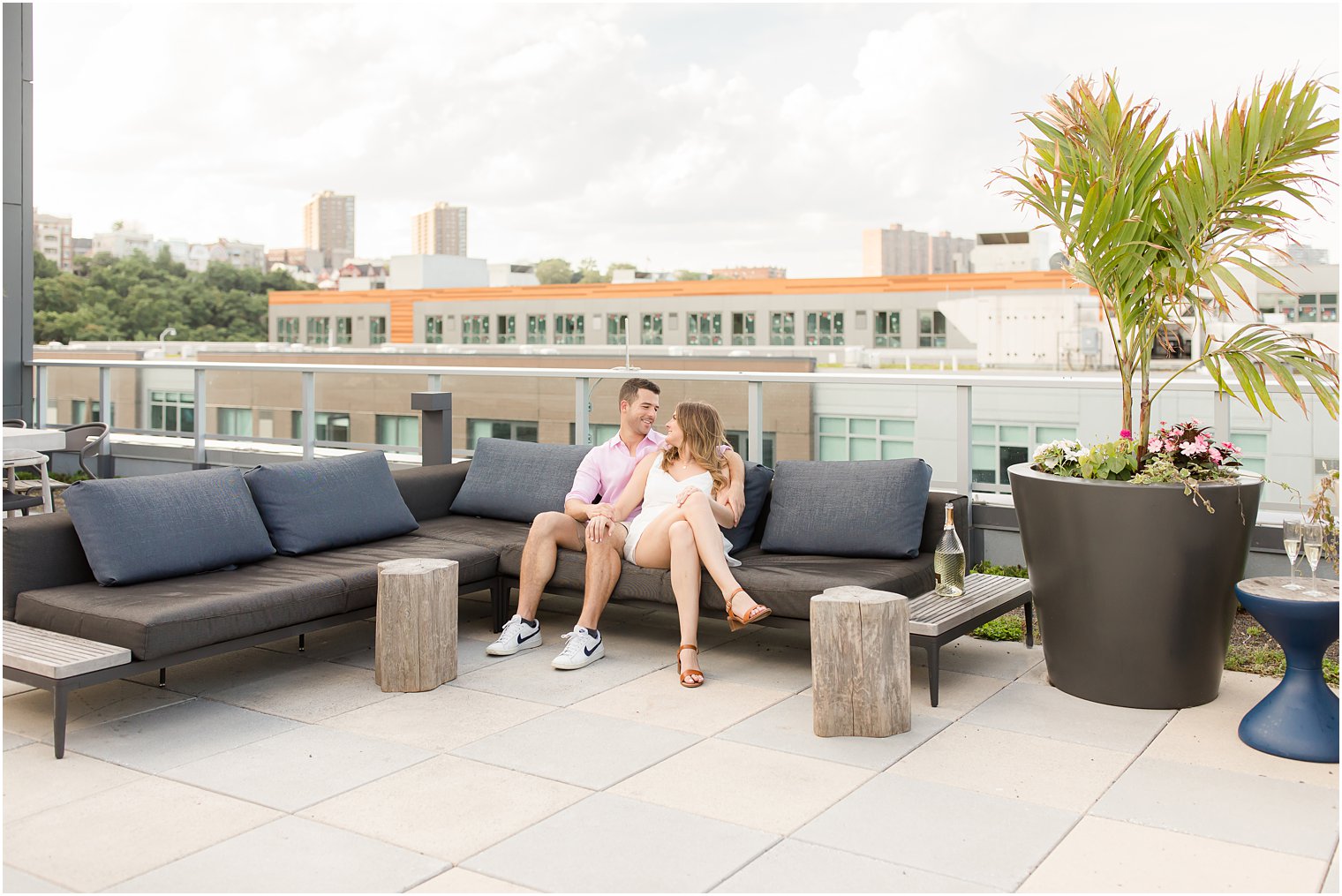 bride and groom pose on rooftop bar in Weehawken NJ