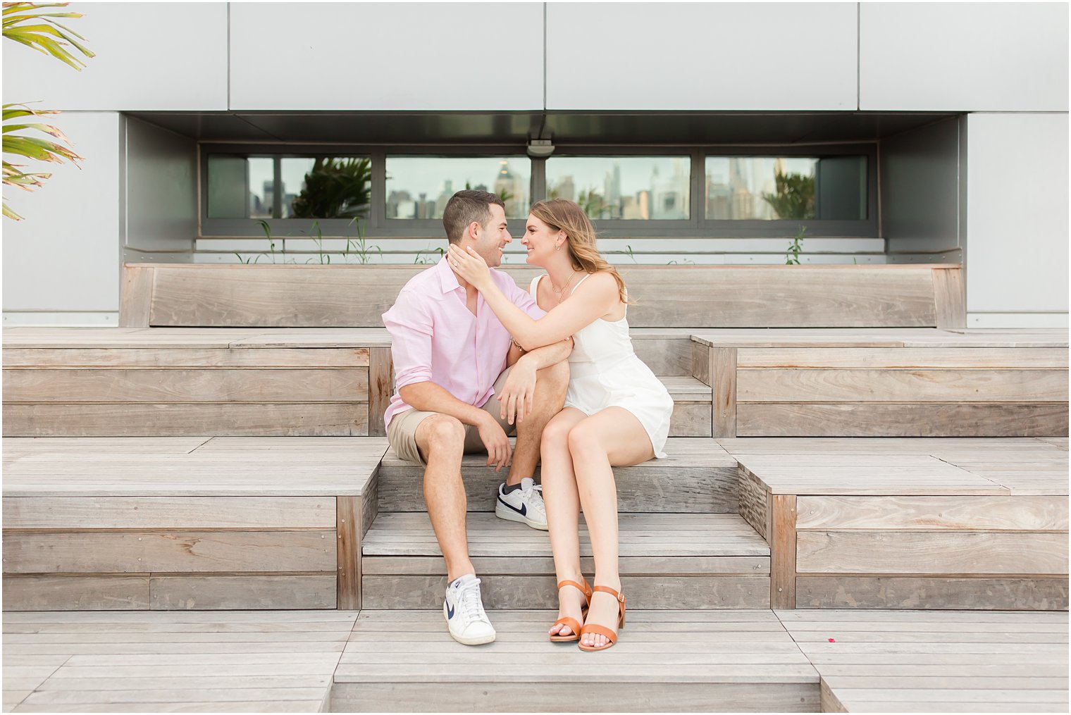 bride and groom sit on wooden steps in Weehawken NJ