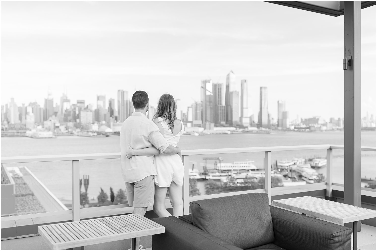 bride and groom hug each other looking at NYC skyline 