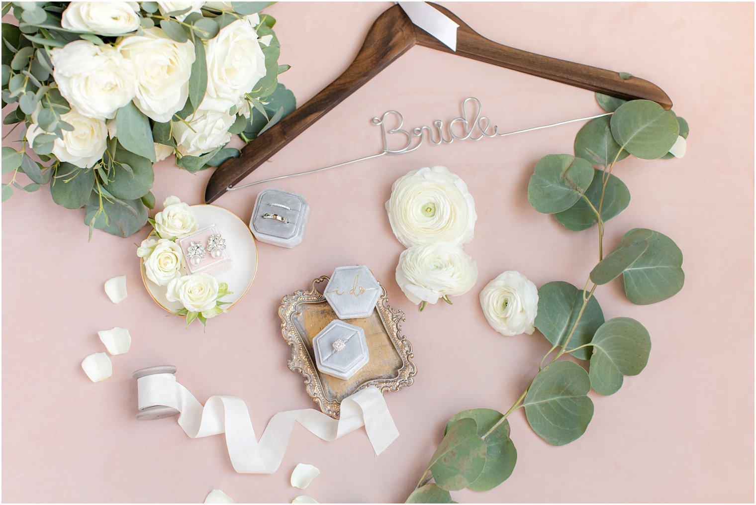 bride hanger with wedding ring in grey box and ivory flowers 