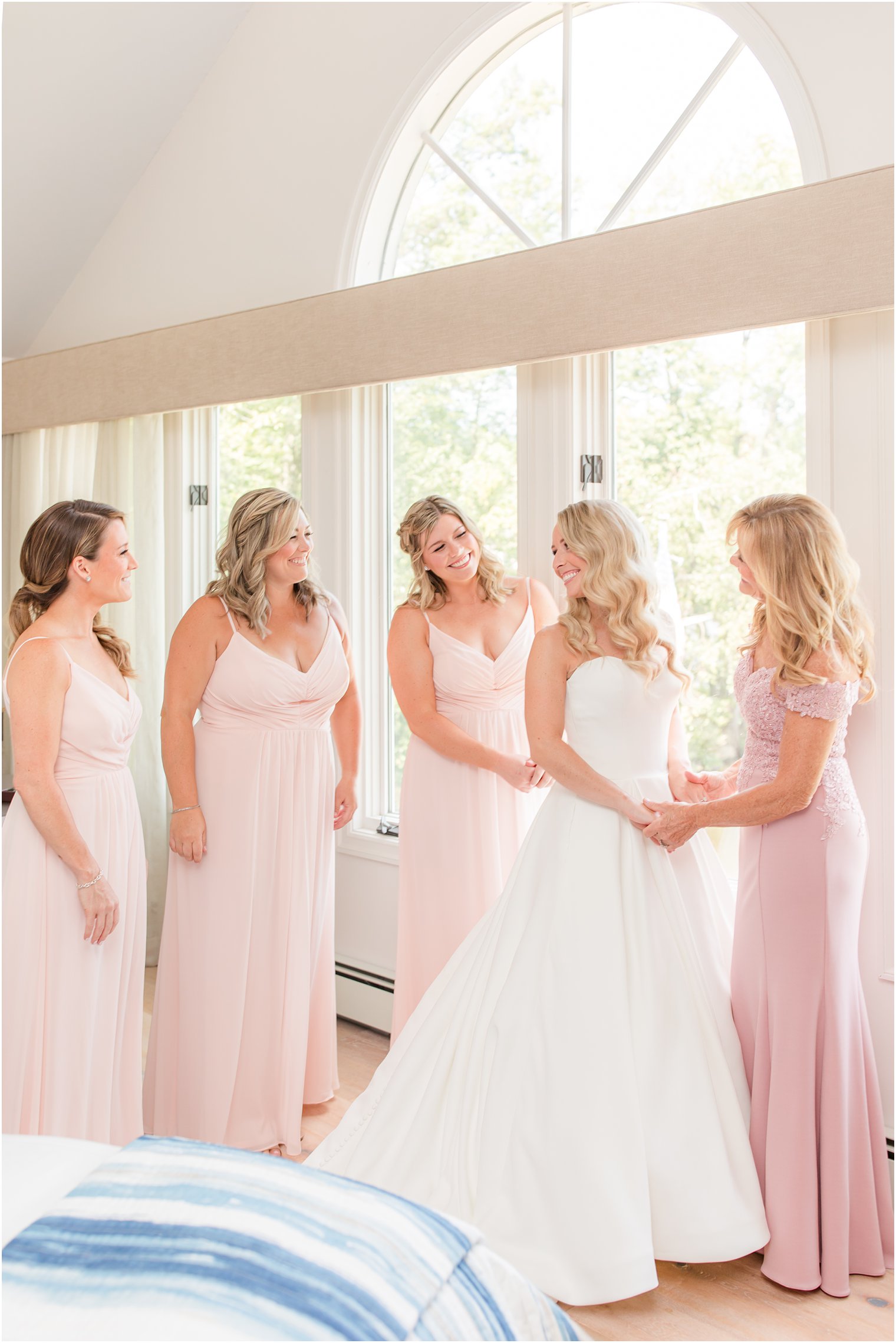 bride and bridesmaids in pink gowns prepare for NJ wedding day