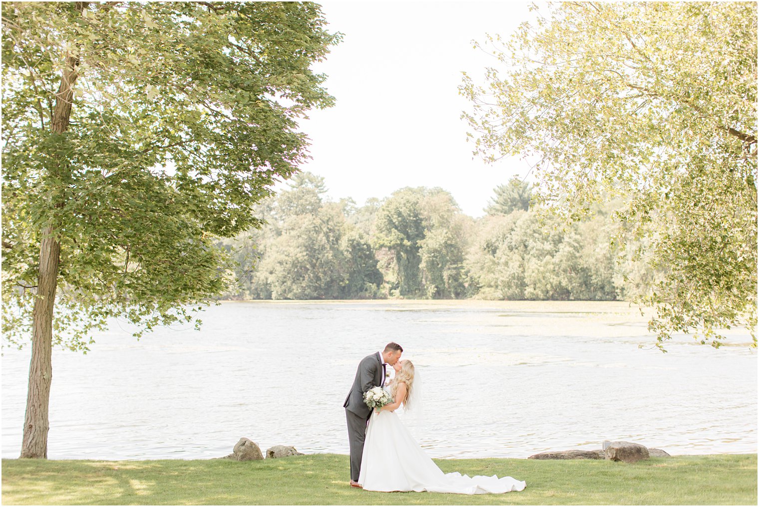 newlyweds kiss during New Jersey wedding portraits 