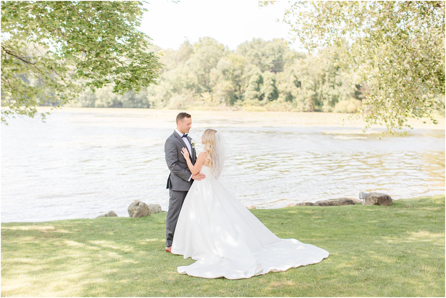 bride stands in front of groom during Indian Trail Club wedding portraits 