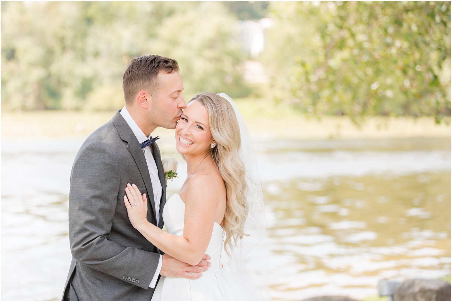 groom kisses bride's temple during Indian Trail Club wedding portraits