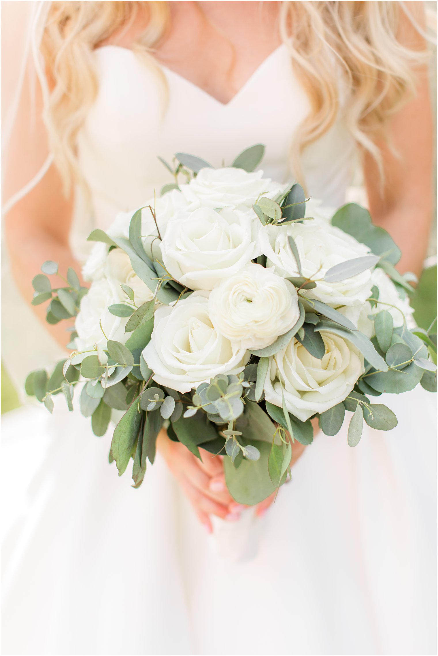 bride holds bouquet of white roses for summer Indian Trail Club wedding day