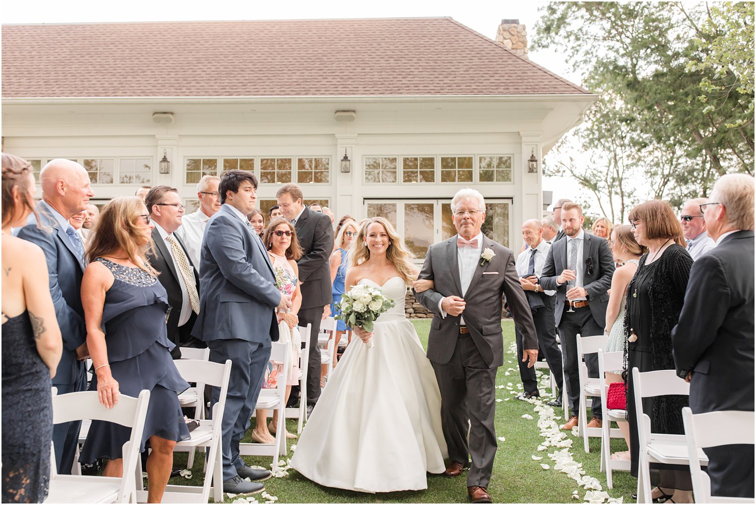 bride walks down aisle with dad during outdoor wedding ceremony in Franklin Lakes