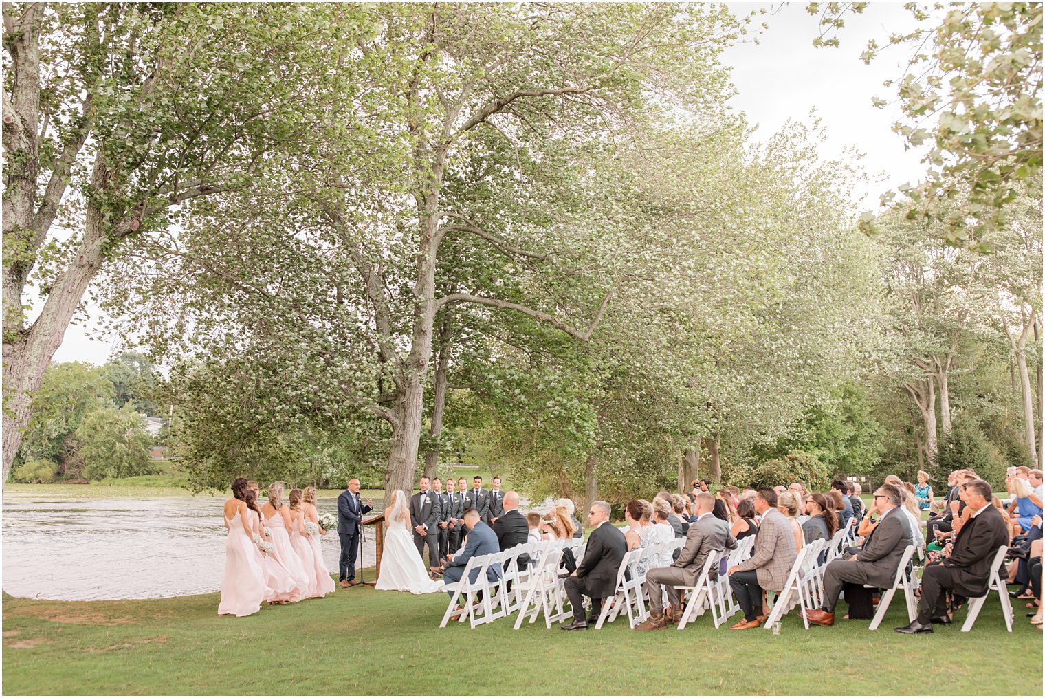 bride and groom stand during outdoor wedding ceremony in Franklin Lakes