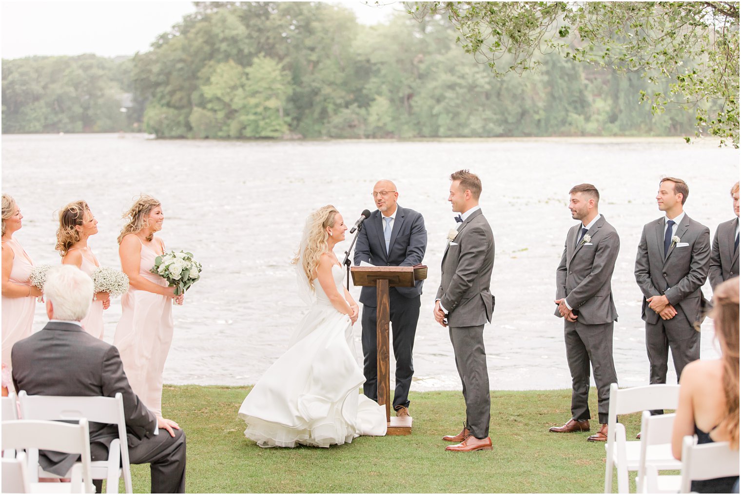 newlyweds look at each other during outdoor wedding ceremony in Franklin Lakes