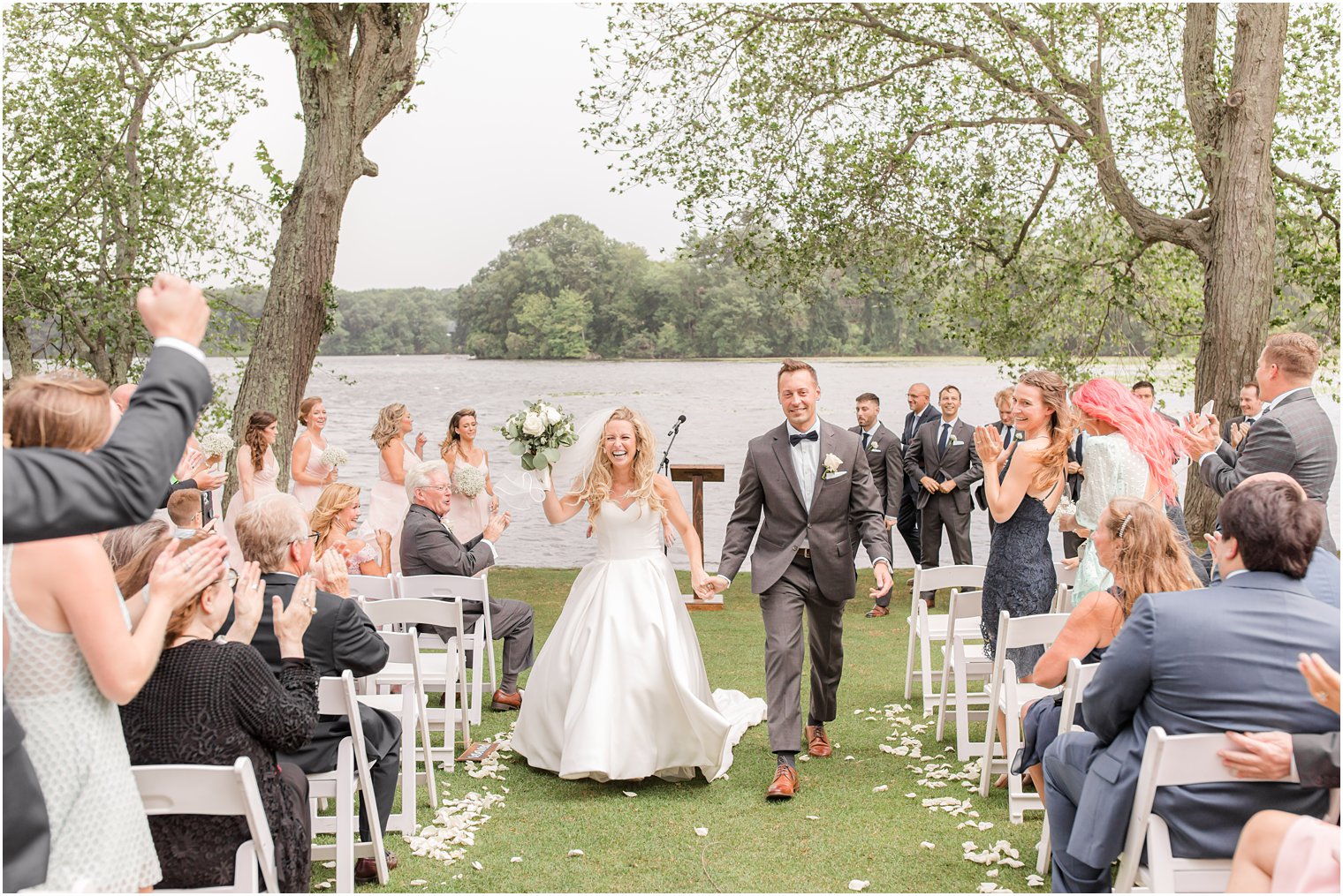 newlyweds walk up aisle after outdoor wedding ceremony in Franklin Lakes